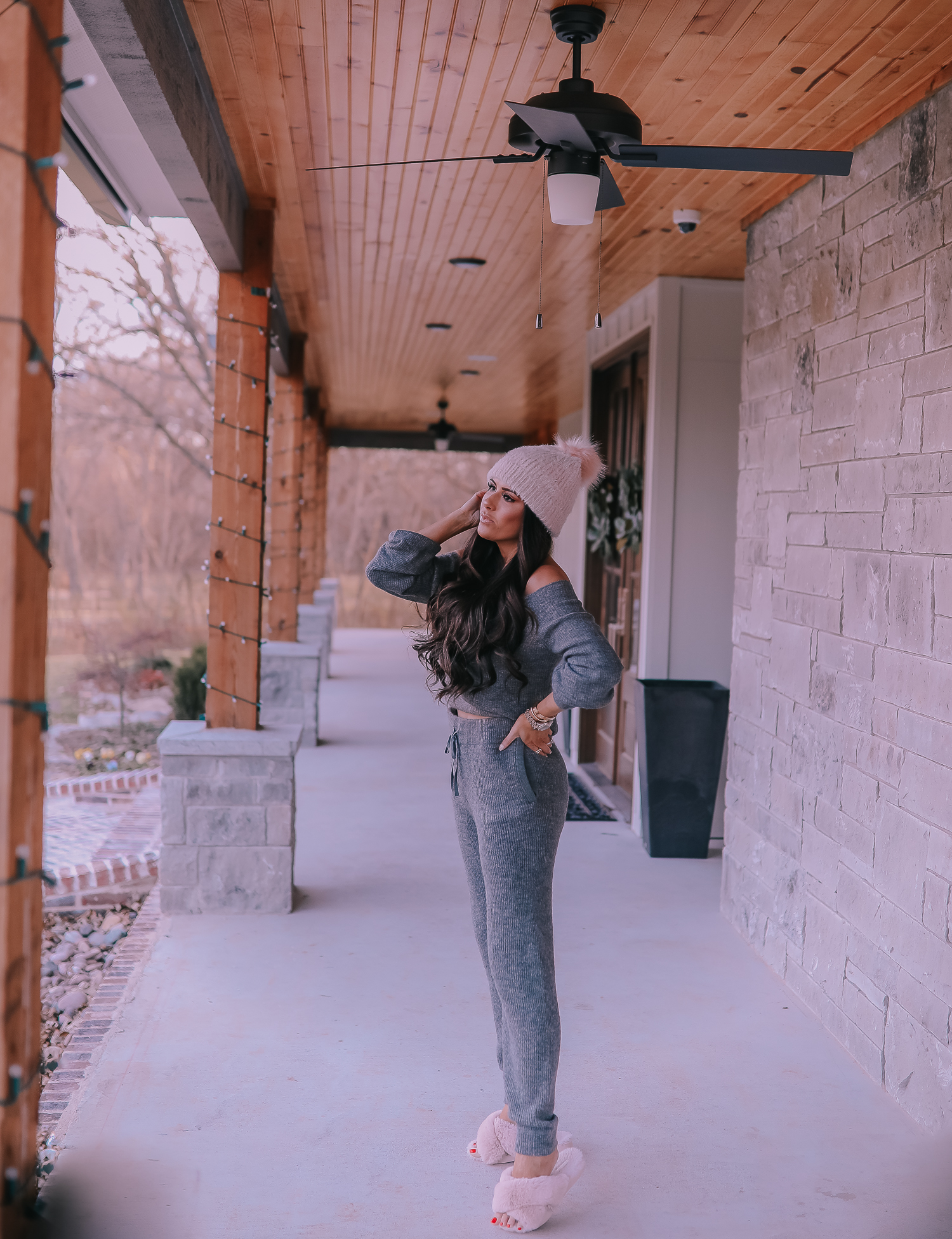 The Perfect Cozy Holiday Outfit [50% Off!] by popular Oklahoma fashion blog, The Sweetest Thing: image of a woman wearing an Express High Waisted Cozy Sweater Jogger Pant, Express Cozy Cropped Ribbed Sweater, Express Metallic Cable Knit Pom Beanie, and Express Criss-Cross Gem Embellished Faux Fur Slippers.