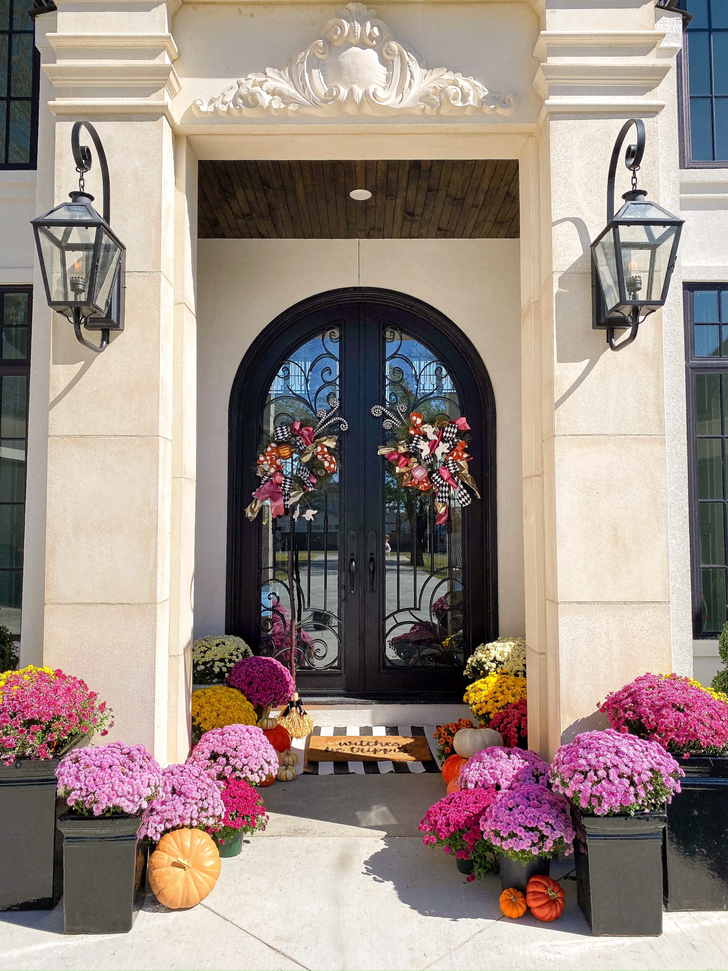 fall front door decor mums pinterest, emily gemma, shop hello holidays | A YEAR IN REVIEW : MASSIVE 2019 INSTAGRAM RECAP by popular Oklahoma life and style blog, The Sweetest Thing: image of a front porch decorated with various colored potted mums and pumpkins. 