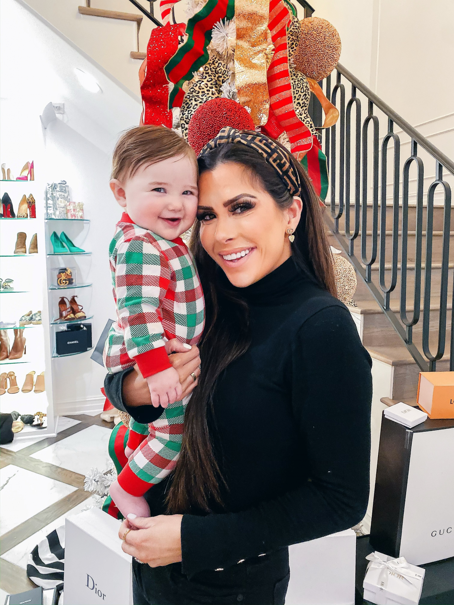 fendi headband, smocked auction christmas pajamas, emily gemma | A YEAR IN REVIEW : MASSIVE 2019 INSTAGRAM RECAP by popular Oklahoma life and style blog, The Sweetest Thing: image of a woman holding her baby and wearing an H&M Fine-knit Turtleneck Sweater and Amazon Fendi Dupe headband.