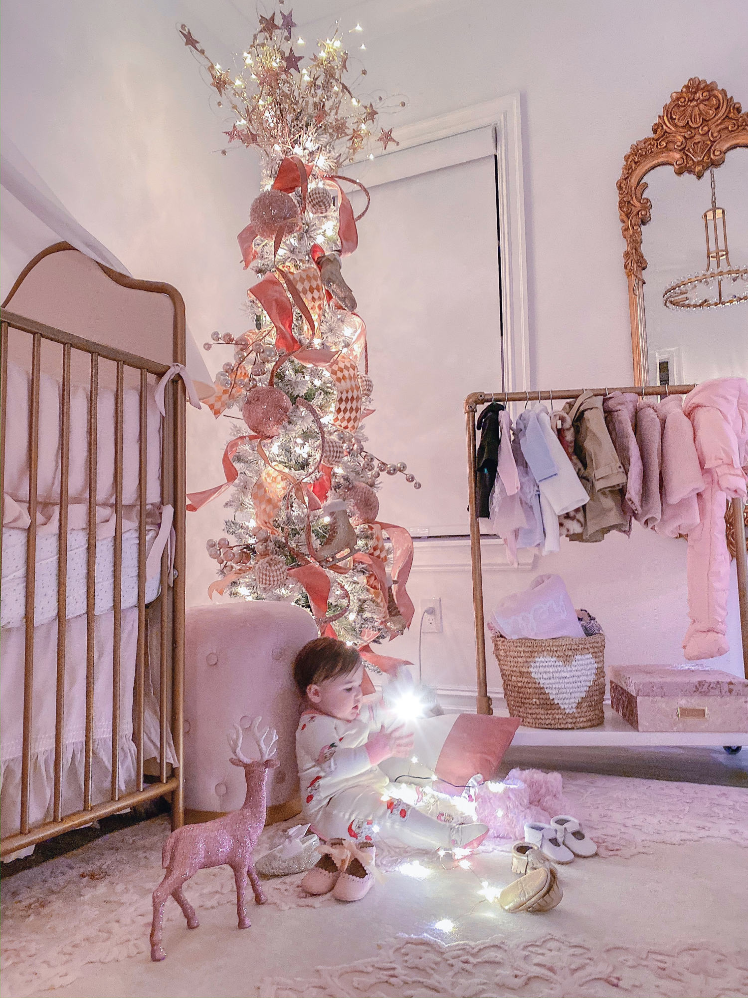 A YEAR IN REVIEW : MASSIVE 2019 INSTAGRAM RECAP by popular Oklahoma life and style blog, The Sweetest Thing: image of a baby sitting on her floor in her nursery and playing with some twinkle lights. 