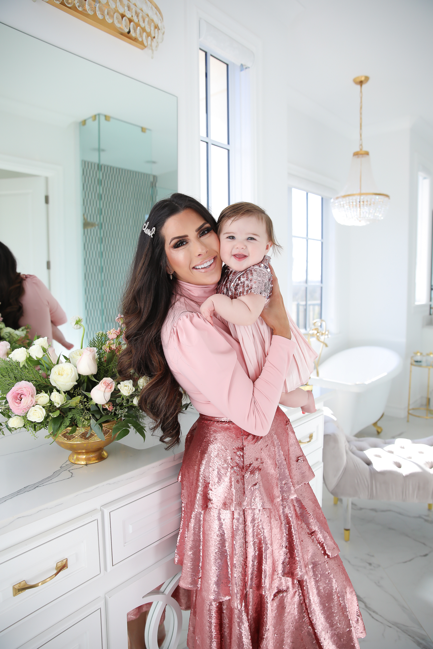 Sparkly Sequin Holiday Outfits by popular Oklahoma fashion blog, The Sweetest Thing: image of a mom and daughter in a bathroom wearing a Nordstrom Rachel Parcell Puff Shoulder Turtleneck, Nordstrom Rachel Parcell Tiered Sequin Skirt, Nordstrom Schutz Ariella Sandal, Nordstrom Chanel Crystal Hair Barrette, Nordstrom Charlotte Tilbury Lip Cheat Lip Liner, Nordstrom Charlotte Tilbury Hot Lips Lipstick, Nordstrom Tom Ford Gloss Luxe Moisturizing Lipgloss, and Nordstrom Bardot Junior Nolene Sequin Party Dress.