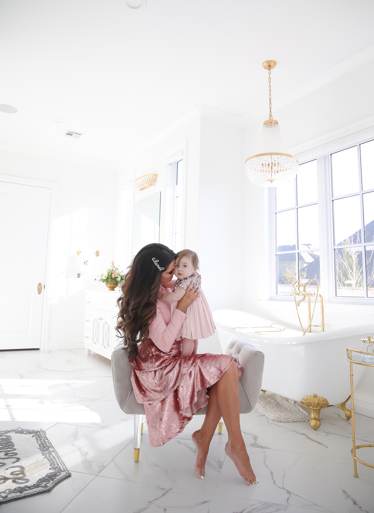 Sparkly Sequin Holiday Outfits by popular Oklahoma fashion blog, The Sweetest Thing: image of a mom and daughter in a bathroom wearing a Nordstrom Rachel Parcell Puff Shoulder Turtleneck, Nordstrom Rachel Parcell Tiered Sequin Skirt, Nordstrom Schutz Ariella Sandal, Nordstrom Chanel Crystal Hair Barrette, Nordstrom Charlotte Tilbury Lip Cheat Lip Liner, Nordstrom Charlotte Tilbury Hot Lips Lipstick, Nordstrom Tom Ford Gloss Luxe Moisturizing Lipgloss, and Nordstrom Bardot Junior Nolene Sequin Party Dress.