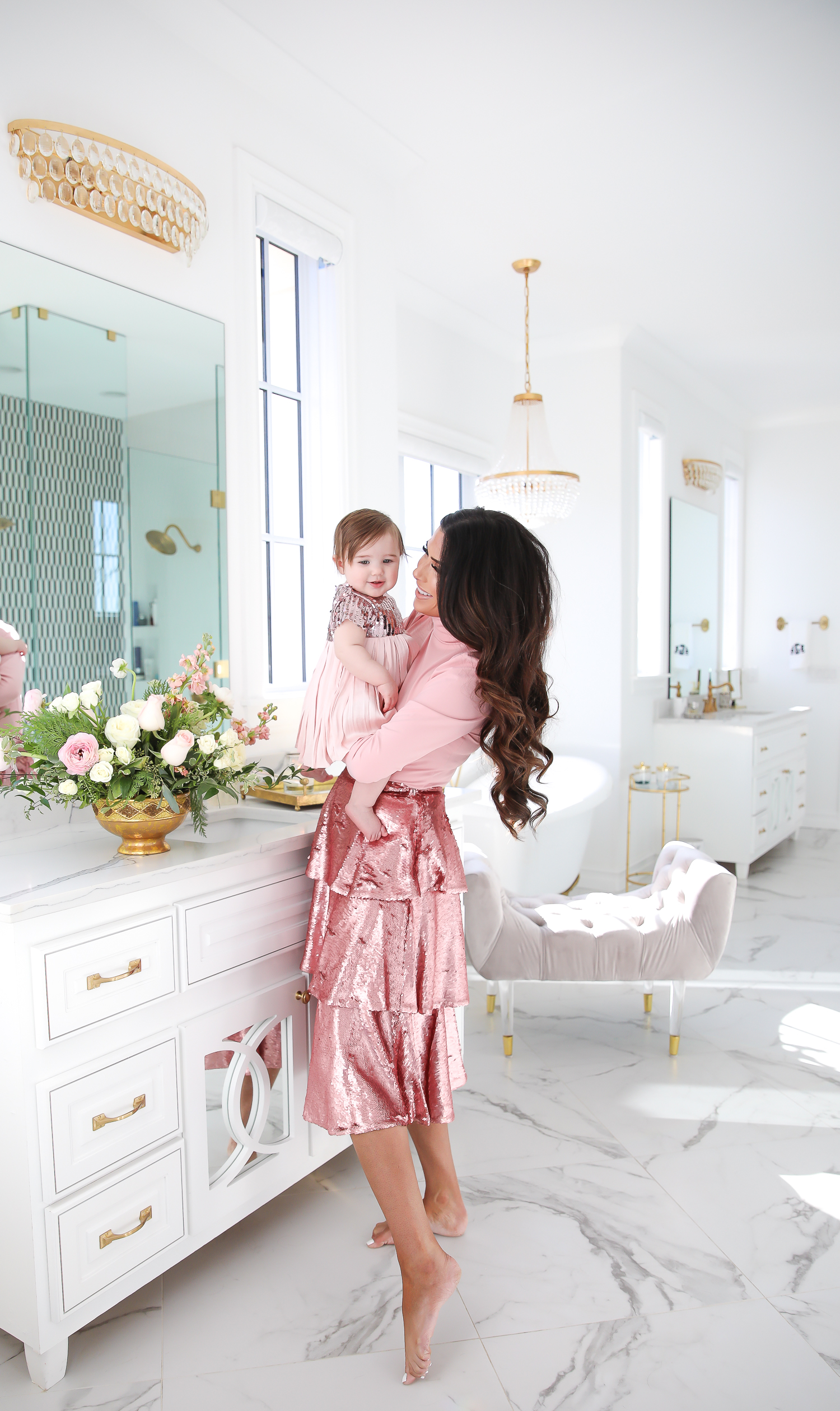 Sparkly Sequin Holiday Outfits by popular Oklahoma fashion blog, The Sweetest Thing: image of a mom and daughter in a bathroom wearing a Nordstrom Rachel Parcell Puff Shoulder Turtleneck, Nordstrom Rachel Parcell Tiered Sequin Skirt, Nordstrom Schutz Ariella Sandal, Nordstrom Chanel Crystal Hair Barrette, Nordstrom Charlotte Tilbury Lip Cheat Lip Liner, Nordstrom Charlotte Tilbury Hot Lips Lipstick, Nordstrom Tom Ford Gloss Luxe Moisturizing Lipgloss, and Nordstrom Bardot Junior Nolene Sequin Party Dress.