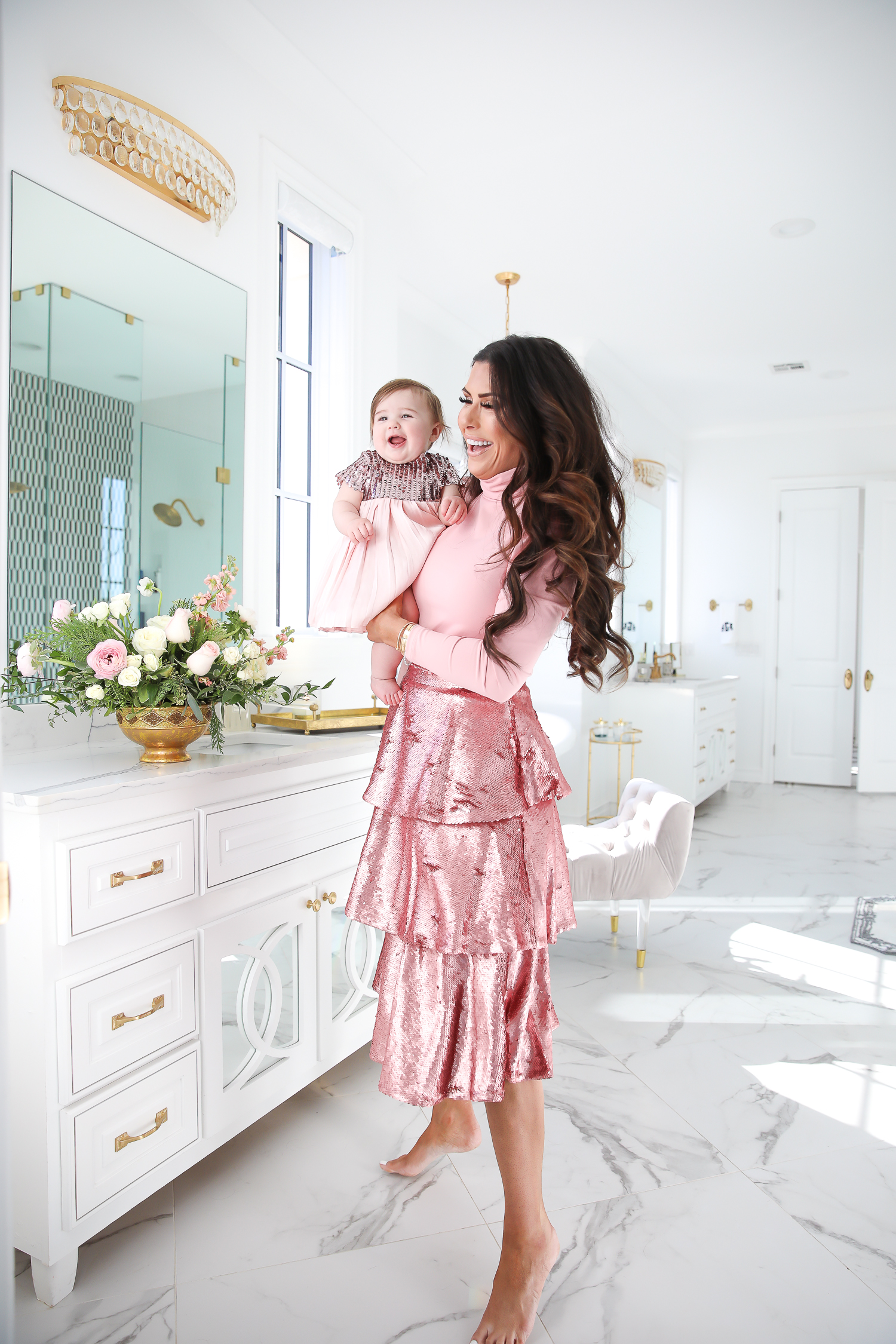 Sparkly Sequin Holiday Outfits by popular Oklahoma fashion blog, The Sweetest Thing: image of a mom and daughter in a bathroom wearing a Nordstrom Rachel Parcell Puff Shoulder Turtleneck, Nordstrom Rachel Parcell Tiered Sequin Skirt, Nordstrom Schutz Ariella Sandal, Nordstrom Chanel Crystal Hair Barrette, Nordstrom Charlotte Tilbury Lip Cheat Lip Liner, Nordstrom Charlotte Tilbury Hot Lips Lipstick, Nordstrom Tom Ford Gloss Luxe Moisturizing Lipgloss, and Nordstrom Bardot Junior Nolene Sequin Party Dress.