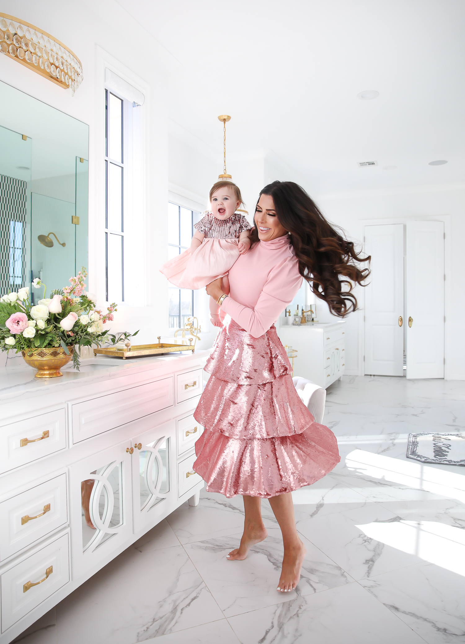 Sparkly Sequin Holiday Outfits by popular Oklahoma fashion blog, The Sweetest Thing: image of a mom and daughter in a bathroom wearing a Nordstrom Rachel Parcell Puff Shoulder Turtleneck, Nordstrom Rachel Parcell Tiered Sequin Skirt, Nordstrom Schutz Ariella Sandal, Nordstrom Chanel Crystal Hair Barrette, Nordstrom Charlotte Tilbury Lip Cheat Lip Liner, Nordstrom Charlotte Tilbury Hot Lips Lipstick, Nordstrom Tom Ford Gloss Luxe Moisturizing Lipgloss, and Nordstrom Bardot Junior Nolene Sequin Party Dress.