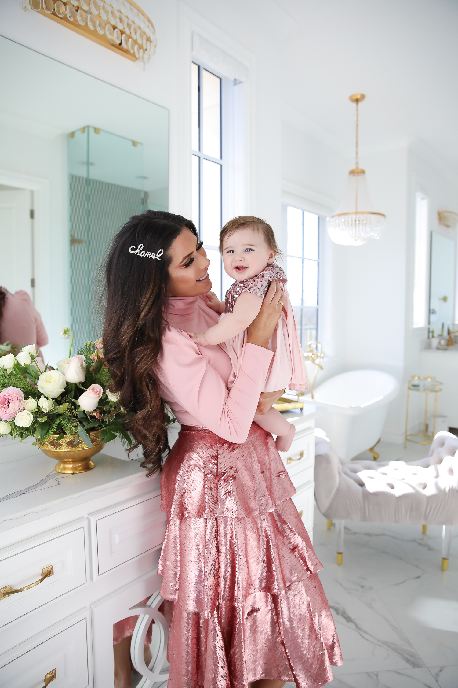 Sparkly Sequin Holiday Outfits by popular Oklahoma fashion blog, The Sweetest Thing: image of a mom and daughter in a bathroom wearing a Nordstrom Rachel Parcell Puff Shoulder Turtleneck, Nordstrom Rachel Parcell Tiered Sequin Skirt, Nordstrom Schutz Ariella Sandal, Nordstrom Chanel Crystal Hair Barrette, Nordstrom Charlotte Tilbury Lip Cheat Lip Liner, Nordstrom Charlotte Tilbury Hot Lips Lipstick, Nordstrom Tom Ford Gloss Luxe Moisturizing Lipgloss, and Nordstrom Bardot Junior Nolene Sequin Party Dress.