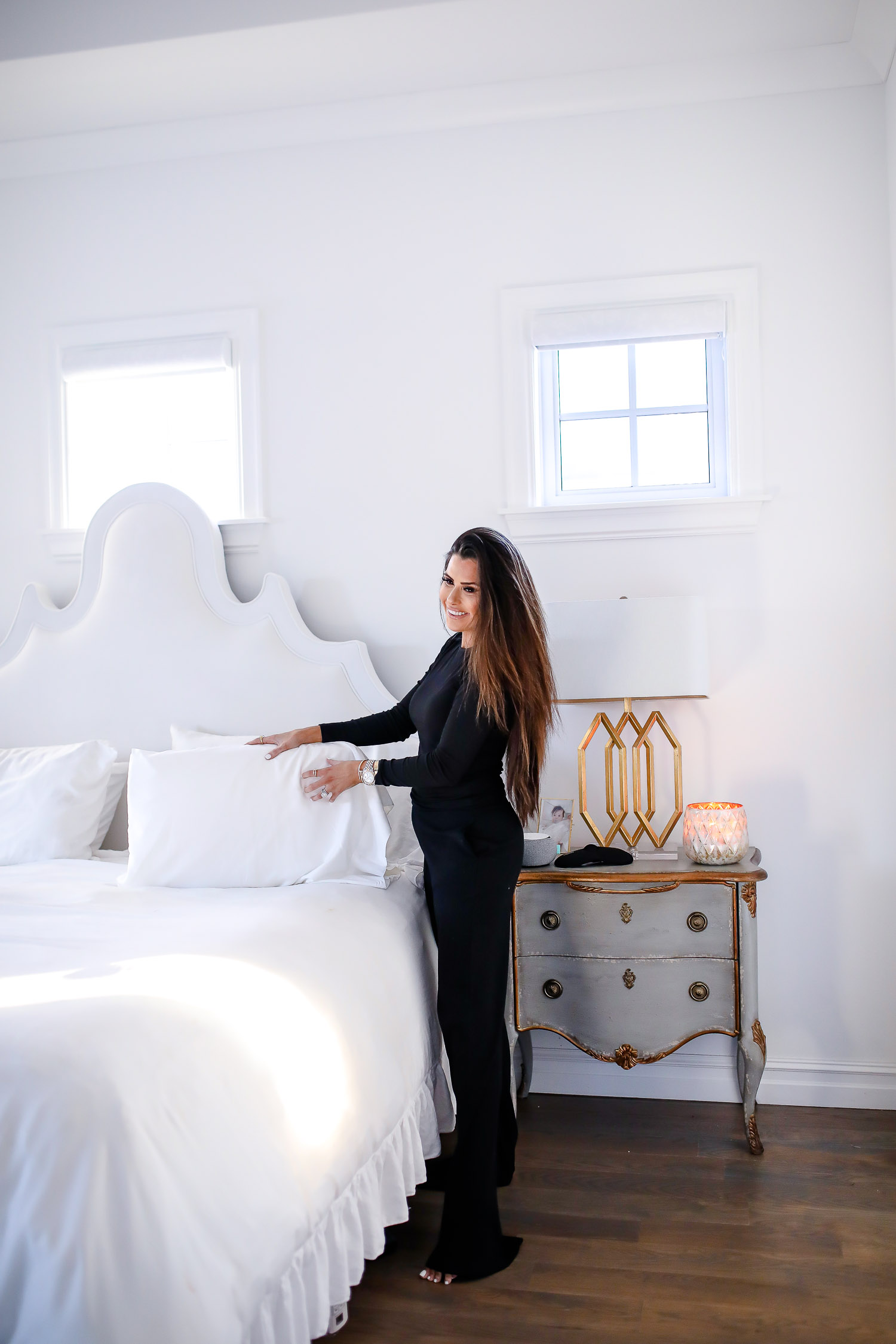 verishop, verishop review, pinterest master bedroom inspo, emily gemma, hooker furniture nightstands-2 | Cozy Essentials by popular US fashion blog, The Sweetest Thing: image of a woman standing by her bed and wearing a Verishop LETT Montreal Rib Top and Verishop LETT Heathrow Wide Leg Pant.