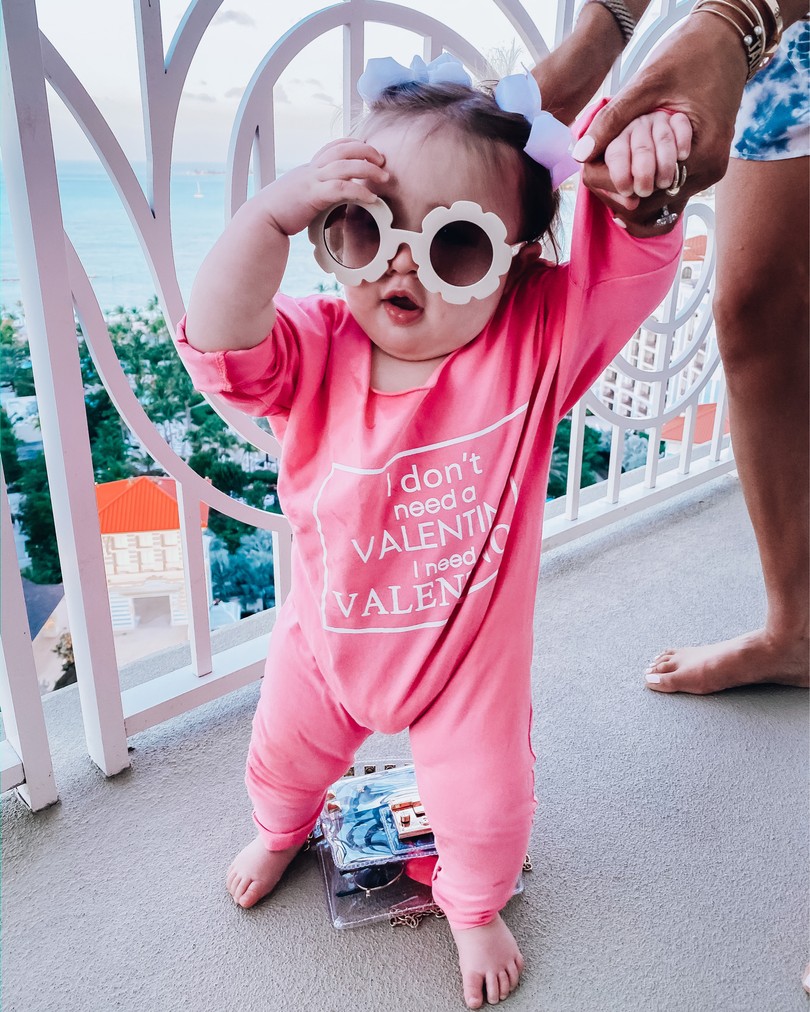 Instagram Fashion by popular US fashion blog, The Sweetest Thing: image of a baby wearing a Amazon Fheaven baby Girls"i don't need a valentine i need valentino" Long Sleeve Romper Jumpsuit, Amazon Roll over image to zoom in ADEWU Sunglasses for Kids Round Flower Cute Glasses UV 400, and Amazon Korobeauty Hair Bows Baby Girls. 