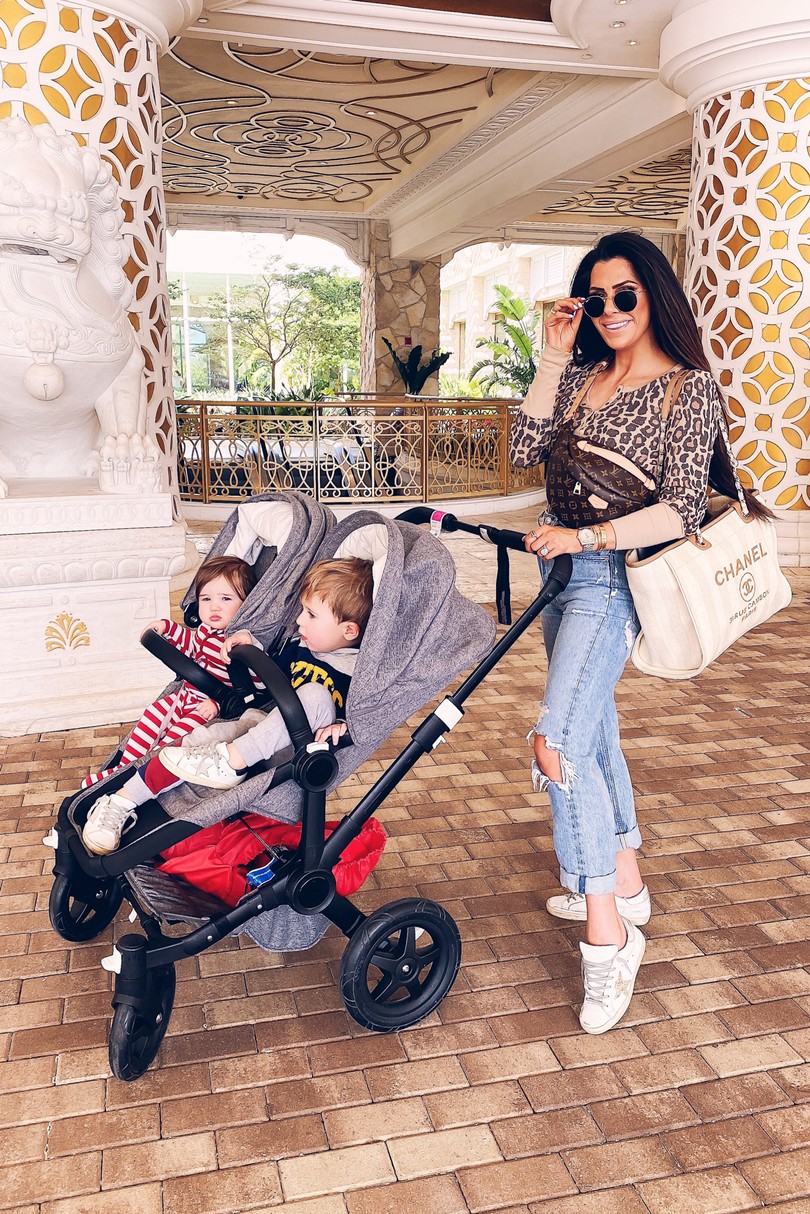 Instagram Fashion by popular US fashion blog, The Sweetest Thing: image of a woman pushing her two kids in a Nordstrom BUGABOO Donkey2 Classic Mono Complete Stroller with Bassinet, Main, color, 025 Donkey2 Classic Mono Complete Stroller with Bassinet BUGABOO and wearing a Revolve Forever Henley Splendid brand: Splendid, Revolve 90s Mid Rise Loose Fit AGOLDE brand: AGOLDE, Nordstrom Superstar Low Top Sneaker GOLDEN GOOSE, Fashionphile Chanel tote, Fashionphile Louis Vuitton bum bag, and Nordstrom Superstar Low Top Sneaker GOLDEN GOOSE.