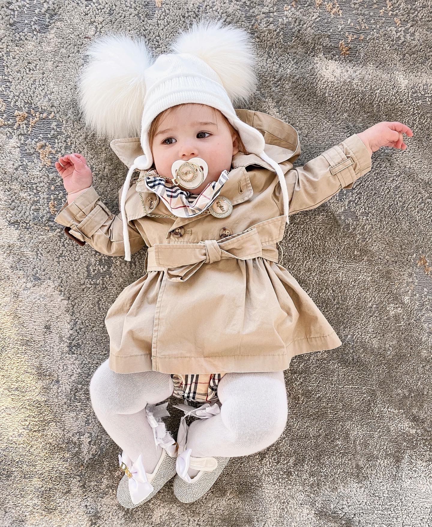 Instagram Recap by popular US fashion blog, The Sweetest Thing: image of a baby wearing a Ralph Lauren trench coat, Etsy Minilittlebaby Gold Pleated Personalised DUMMY AND Chain pacifier, Etsy Minilittlebaby Pacifier Clip, Etsy Minilittlebaby personalized Pearl Baby Girl shoes, and Gap Toddler Cable-Knit Pom Beanie.