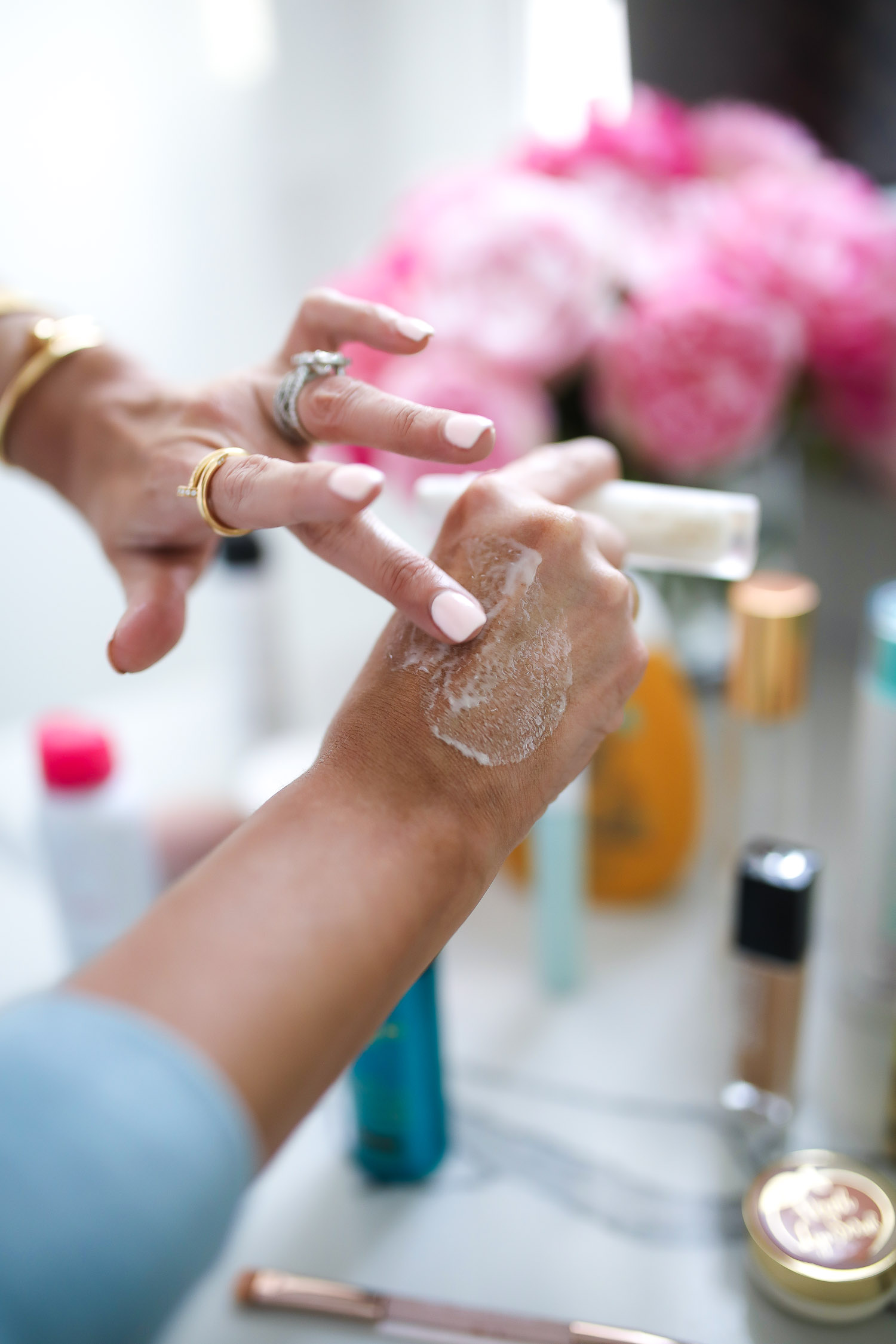 Sephora Favorites by popular US beauty blog, The Sweetest Thing: image of a woman applying a cream to her hand. 