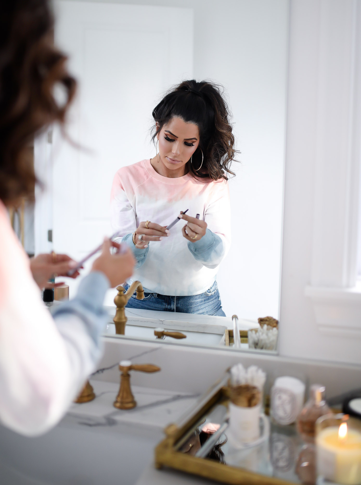 Sephora Favorites by popular US beauty blog, The Sweetest Thing: image of a woman holding eyeliner.