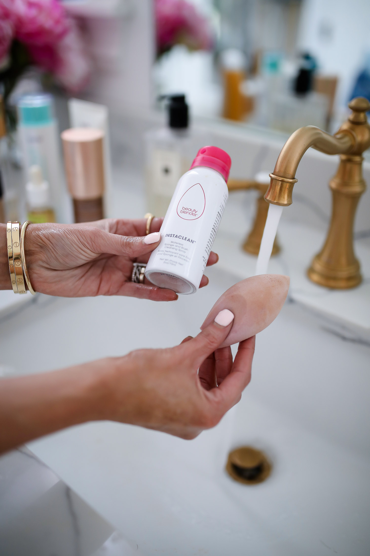 Sephora Favorites by popular US beauty blog, The Sweetest Thing: image of a woman holding a beauty blender and a bottle of beauty blender cleaner.