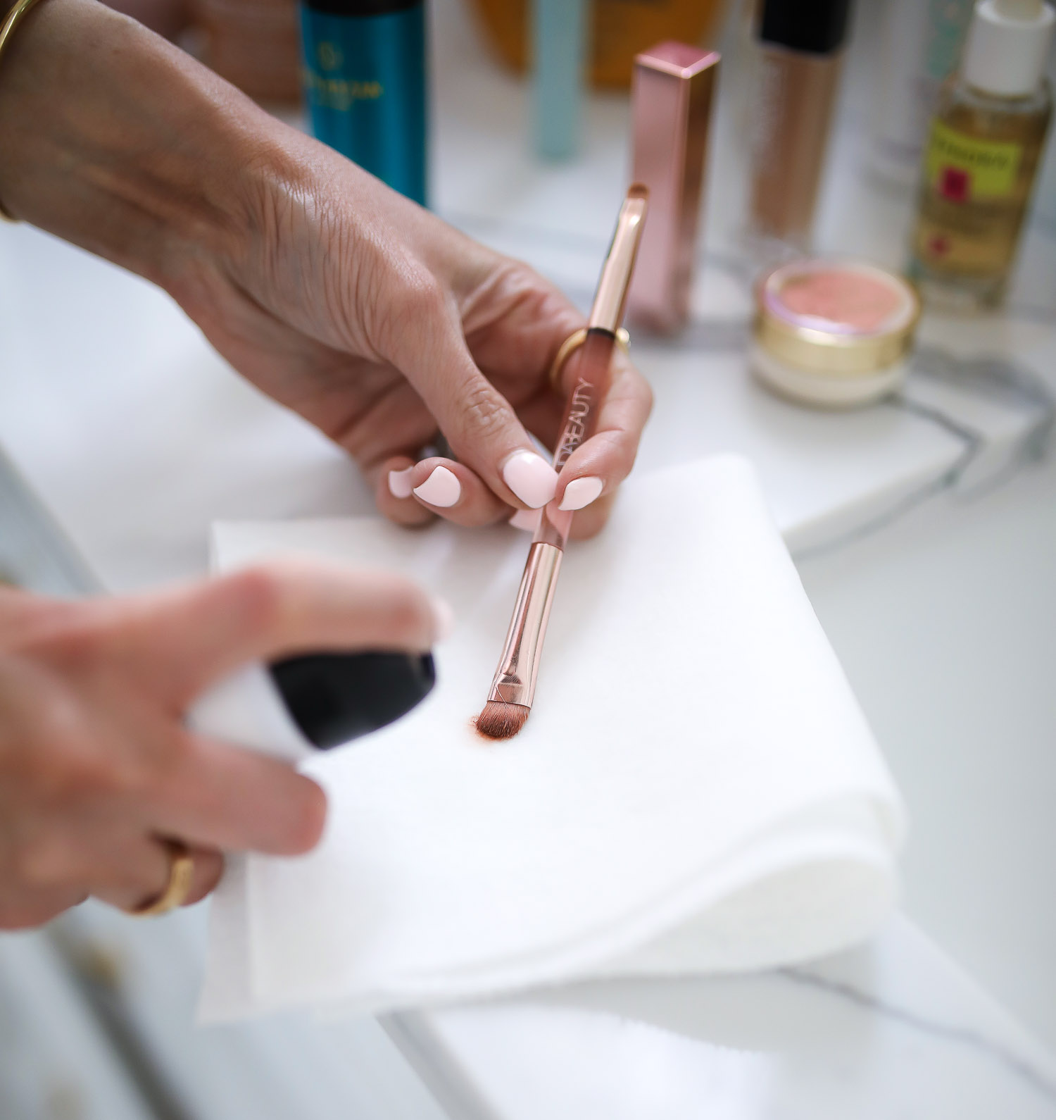 Sephora Favorites by popular US beauty blog, The Sweetest Thing: image of a woman holding a Huda Beauty makeup brush. 