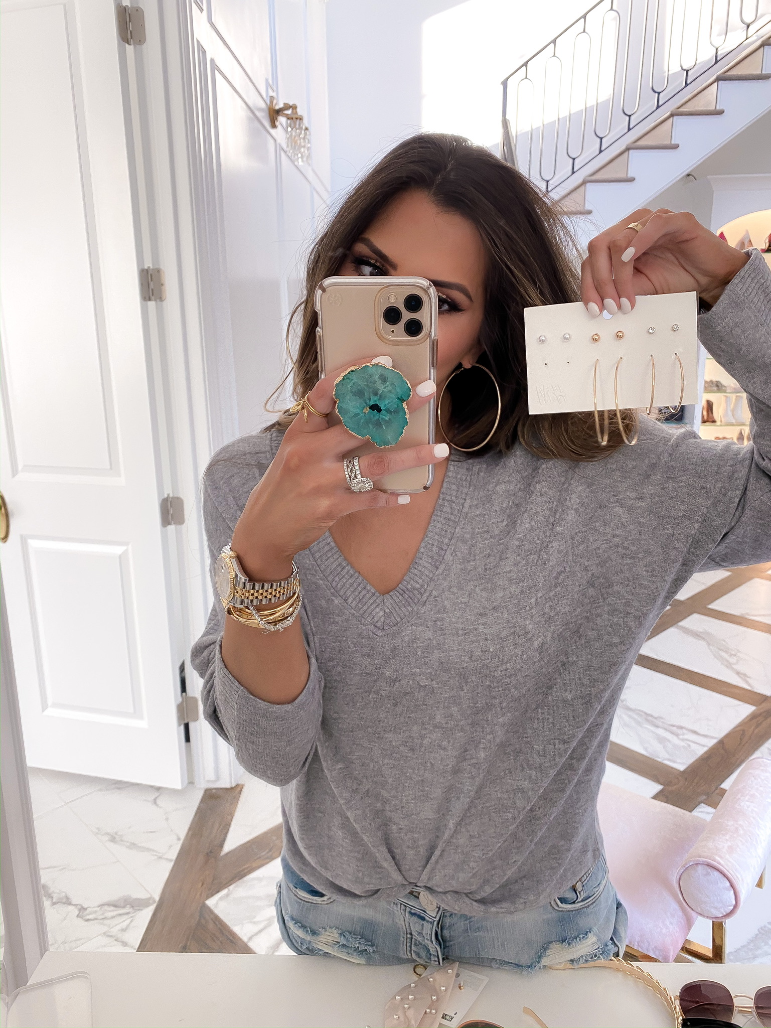 Blogging Newsletter by popular US life and style blog, The Sweetest Thing: image of a woman holding some H&M 6-pack Earrings and Studs.