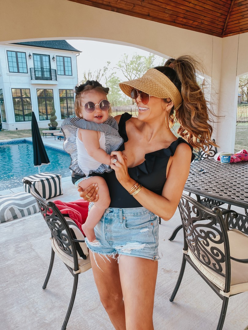 Instagram Recap by popular US lifestyle blog, The Sweetest Thing: image of Emily Gemma holding her daughter and wearing a So Solid Loreta One Piece  eberjey brand: eberjey, DIOR DIORSOCIETY2 ROUND BEADED METAL SUNGLASSES, Straw Visor BP., Shopbop One Teaspoon Hendrix Bandit Shorts, Amazon SA106 Kids Child Size Hippie Round Circle Lens Tie Dye Gradient Metal Sunglasses, Etsy One Piece Girl Swimsuit Black with Striped Ruffles, and Amazon Korobeauty Hair Bow. 