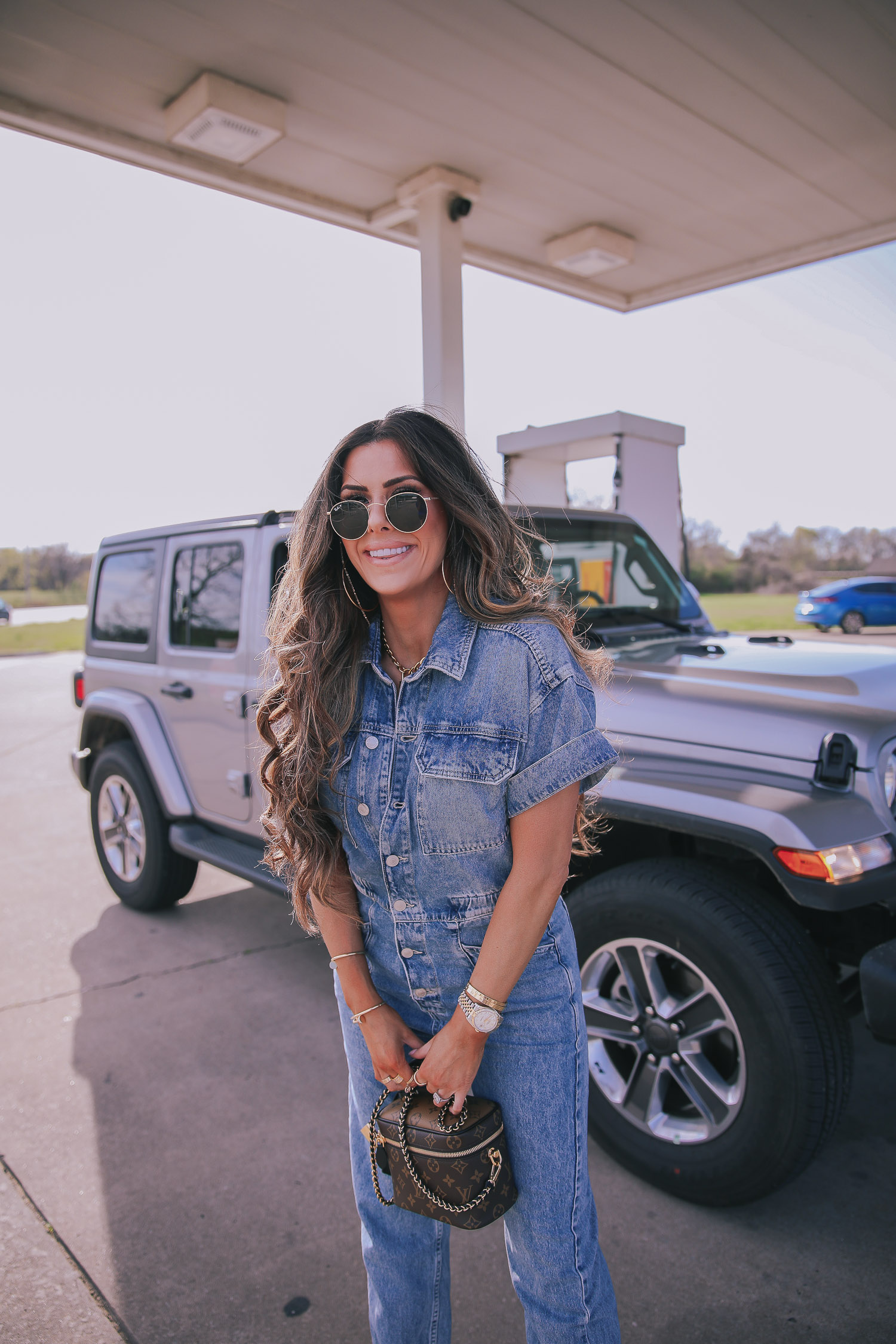 denim jumpsuit, free people denim jumpsuit coverall, emily ann gemma, spring fashion 2020, pinterest spring summer fashion 2020 | Denim Jumpsuit Outfit by popular US fashion blog, The Sweetest Thing: image of Emily Gemma standing in front of a Jeep at a gas station and wearing a Free People Marci Coverall, Cartier rings, Rolex watch, Nordstrom 50mm Retro Inspired Round Metal Sunglasses RAY-BAN, Nordstrom Skyla Slide Sandal TOPSHOP, Ulta KKW BEAUTY  Nude Lip Liner, Nordstrom Hot Lips Lipstick CHARLOTTE TILBURY, and Nordstrom Gloss Luxe Moisturizing Lipgloss TOM FORD.