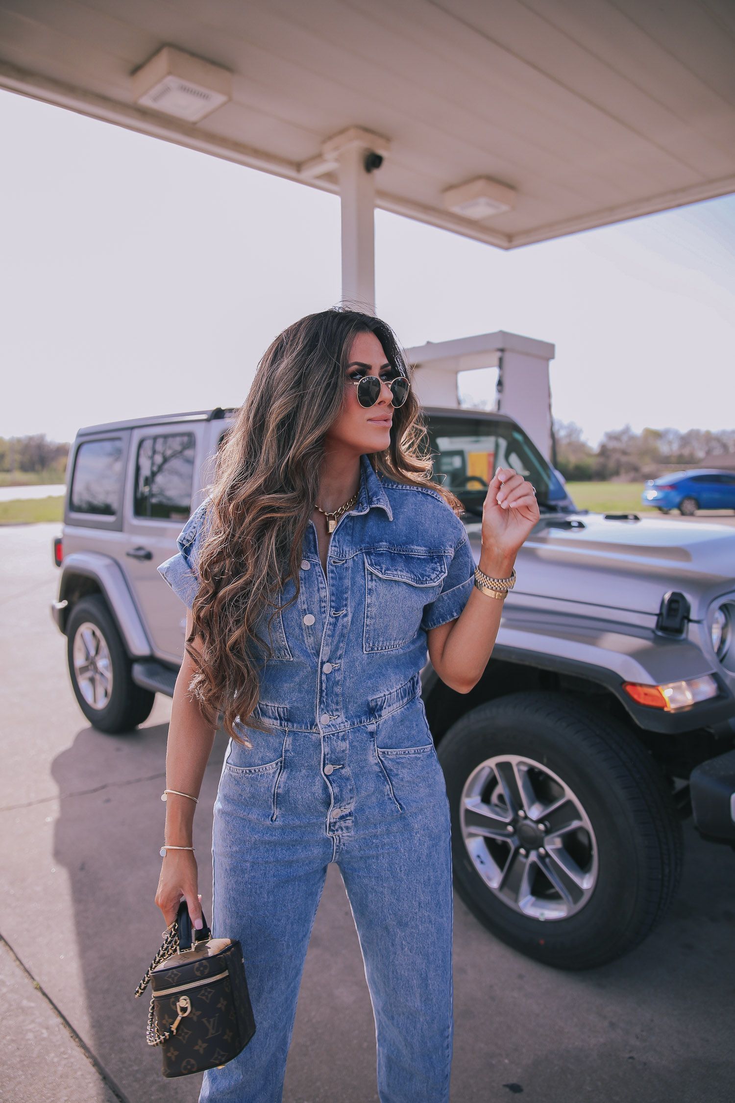 denim jumpsuit, free people denim jumpsuit coverall, emily ann gemma, spring fashion 2020, pinterest spring summer fashion 2020 | Denim Jumpsuit Outfit by popular US fashion blog, The Sweetest Thing: image of Emily Gemma standing in front of a Jeep at a gas station and wearing a Free People Marci Coverall, Cartier rings, Rolex watch, Nordstrom 50mm Retro Inspired Round Metal Sunglasses RAY-BAN, Nordstrom Skyla Slide Sandal TOPSHOP, Ulta KKW BEAUTY  Nude Lip Liner, Nordstrom Hot Lips Lipstick CHARLOTTE TILBURY, and Nordstrom Gloss Luxe Moisturizing Lipgloss TOM FORD.