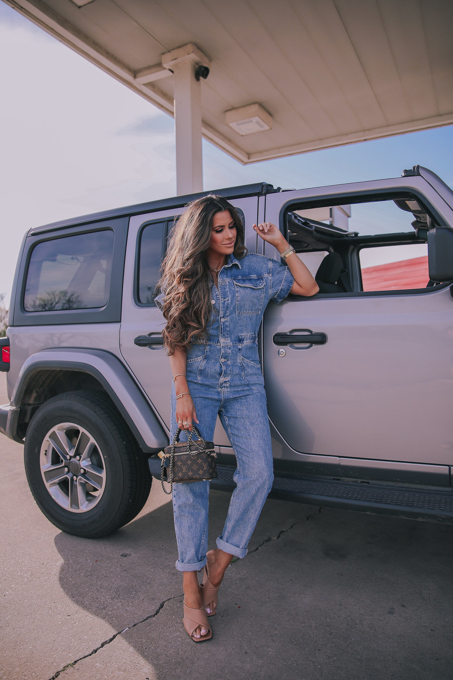 denim jumpsuit, free people denim jumpsuit coverall, emily ann gemma, spring fashion 2020, pinterest spring summer fashion 2020 | Denim Jumpsuit Outfit by popular US fashion blog, The Sweetest Thing: image of Emily Gemma standing in front of a Jeep at a gas station and wearing a Free People Marci Coverall, Cartier rings, Rolex watch, Nordstrom 50mm Retro Inspired Round Metal Sunglasses RAY-BAN, Nordstrom Skyla Slide Sandal TOPSHOP, Ulta KKW BEAUTY  Nude Lip Liner, Nordstrom Hot Lips Lipstick CHARLOTTE TILBURY, and Nordstrom Gloss Luxe Moisturizing Lipgloss TOM FORD.