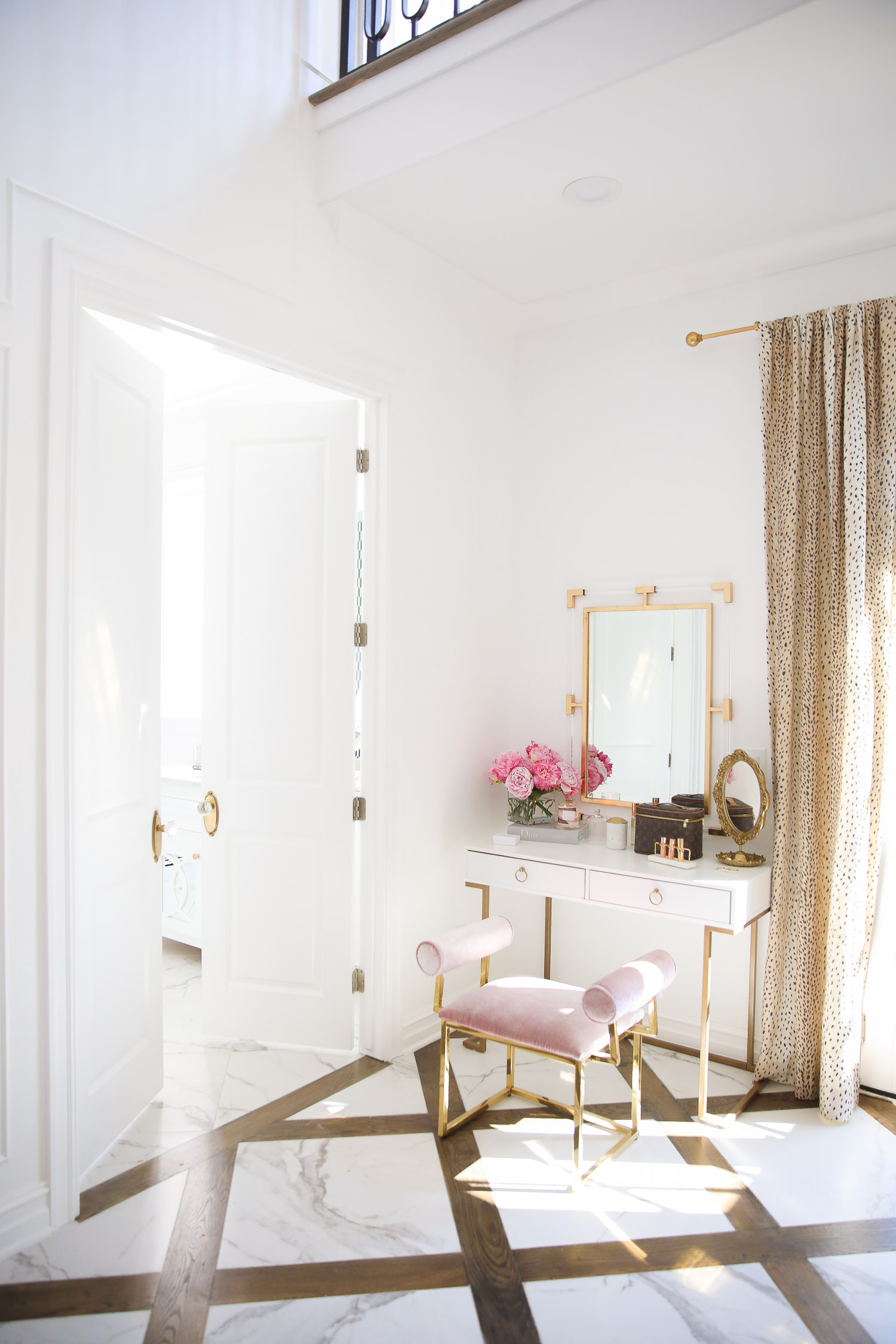 two story closet pinterest, emily gemma closet, home decor luxury blog post3 | Instagram Recap by popular US life and style blog, The Sweetest Thing: image of a white and gold vanity, pink velvet and gold vanity bench, acrylic and gold mirror, Louis Vuitton makeup case, faux peonies, and Embellished gold hand mirror. 