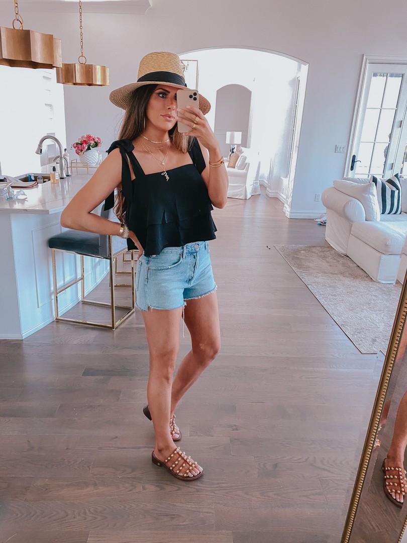 Instagram Recap by popular US life and style blog, The Sweetest Thing: image of Emily Gemma wearing a The Styled Collection Love necklace, black ruffle tank, denim shorts, straw hat, and clear embellished sandals. 