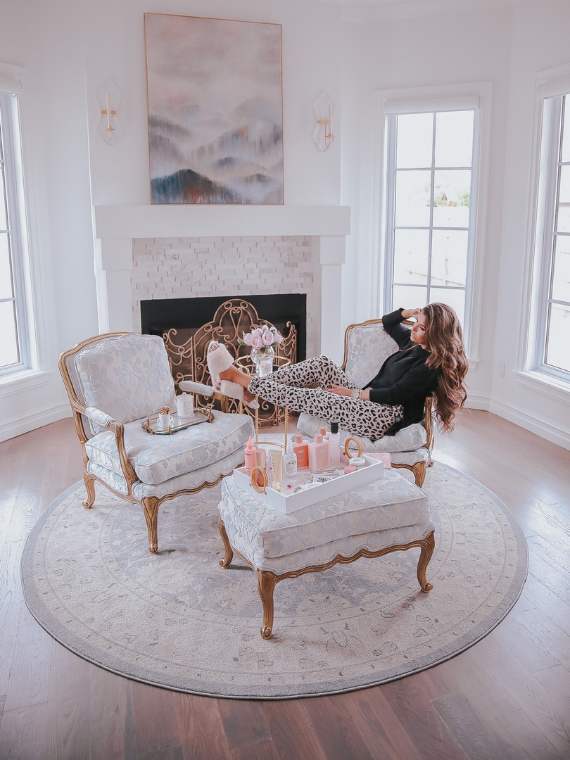 Instagram Recap by popular US life and style blog, The Sweetest Thing: image of Emily Gemma wearing a Steve Madden No Biggie High Low Sweater and sitting in a Little Design Co. chair next to a Little Design Co. ottoman with a Wayfair Mirrored Brass Accent Tray on it. 