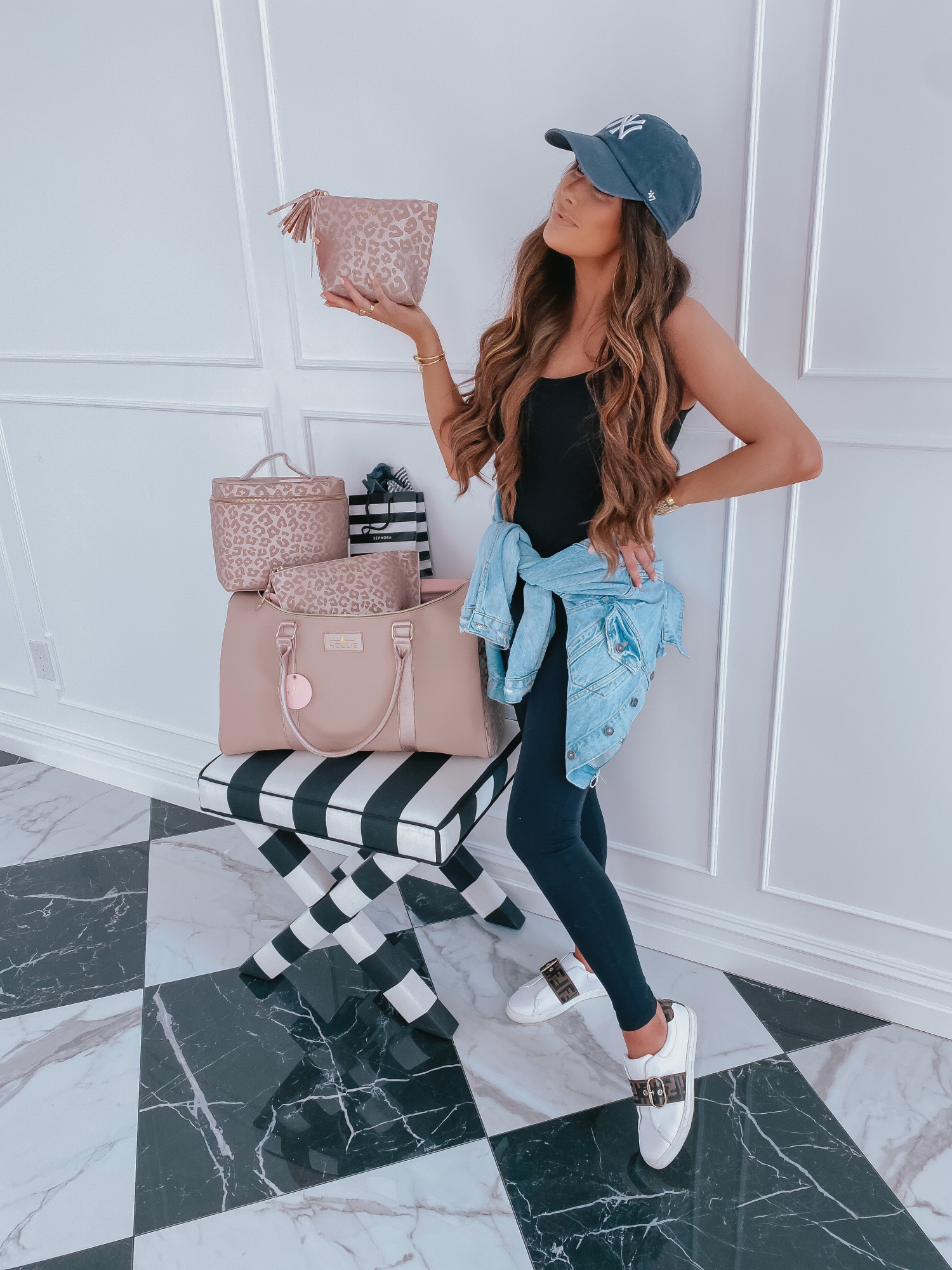 Cute Workout Clothes by popular US fashion blog, The Sweetest Thing: image of Emily Gemma wearing a Vince tank, Fendi sneakers, Zella leggings, Free People denim jacket, and a Urban Outfitters Yankies ball cap. 