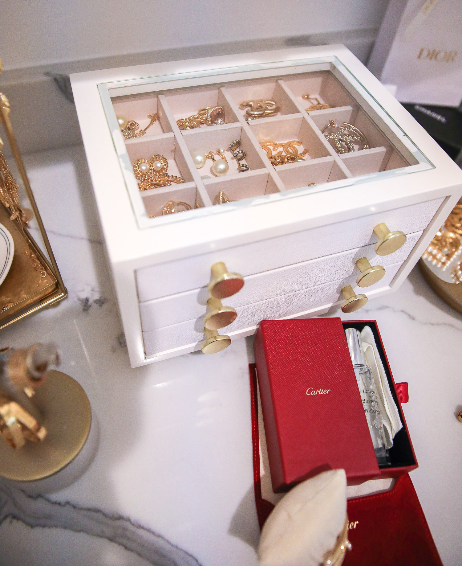 jewelry organization, how to store jewelry, Cartier jewelry cleaner | Nighttime Routine by popular US beauty blog, The Sweetest Thing: image of Cartier jewelry cleaner Chanel earrings in a Jewelry box. 