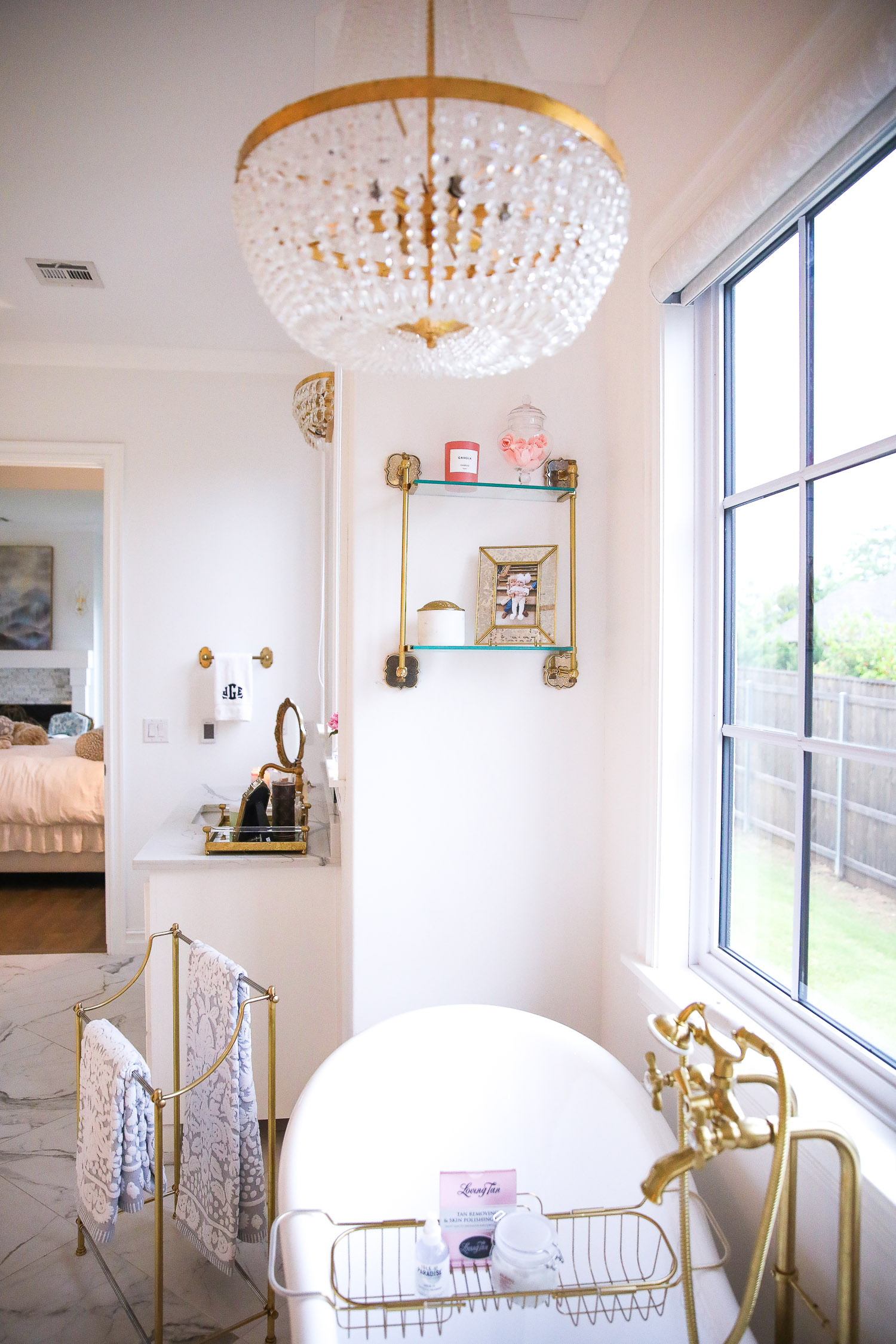 all white gold master bathroom, white gold clawfoot tub, emily ann gemma, pinterest master bathroom design decor, elemis review, rolex watch winder-2 | Nighttime Routine by popular US beauty blog, The Sweetest Thing: image of a bathroom with a gold Towel Rack, Bath Towels, Gold Tray w/Perfumes,, Gold Bath Caddy, Cecilia Jewelry Stand, Gaia Silk Overose Candle, Jo Malone London Hand & Body Wash. Anthropologie Cloche Candle, Gold Vanity Mirror, Monogrammed Hand Towels, and Marble and Gold Canister.