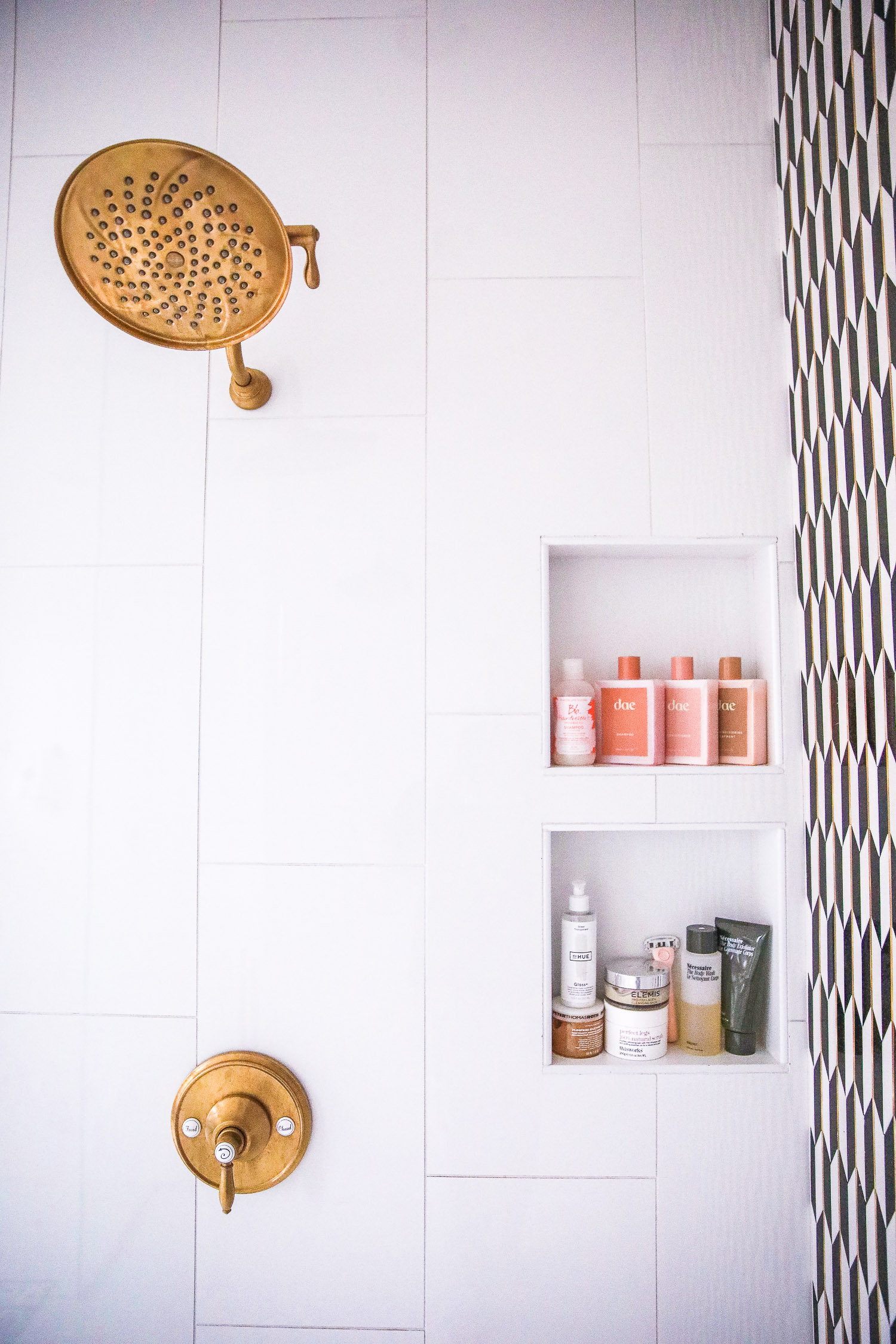 dae shampoo and conditioner | Nighttime Routine by popular US beauty blog, The Sweetest Thing: image of a bathroom shower with a gold shower head, and Dae shampoo, Dae conditioner, and Dae deep conditioner. 
