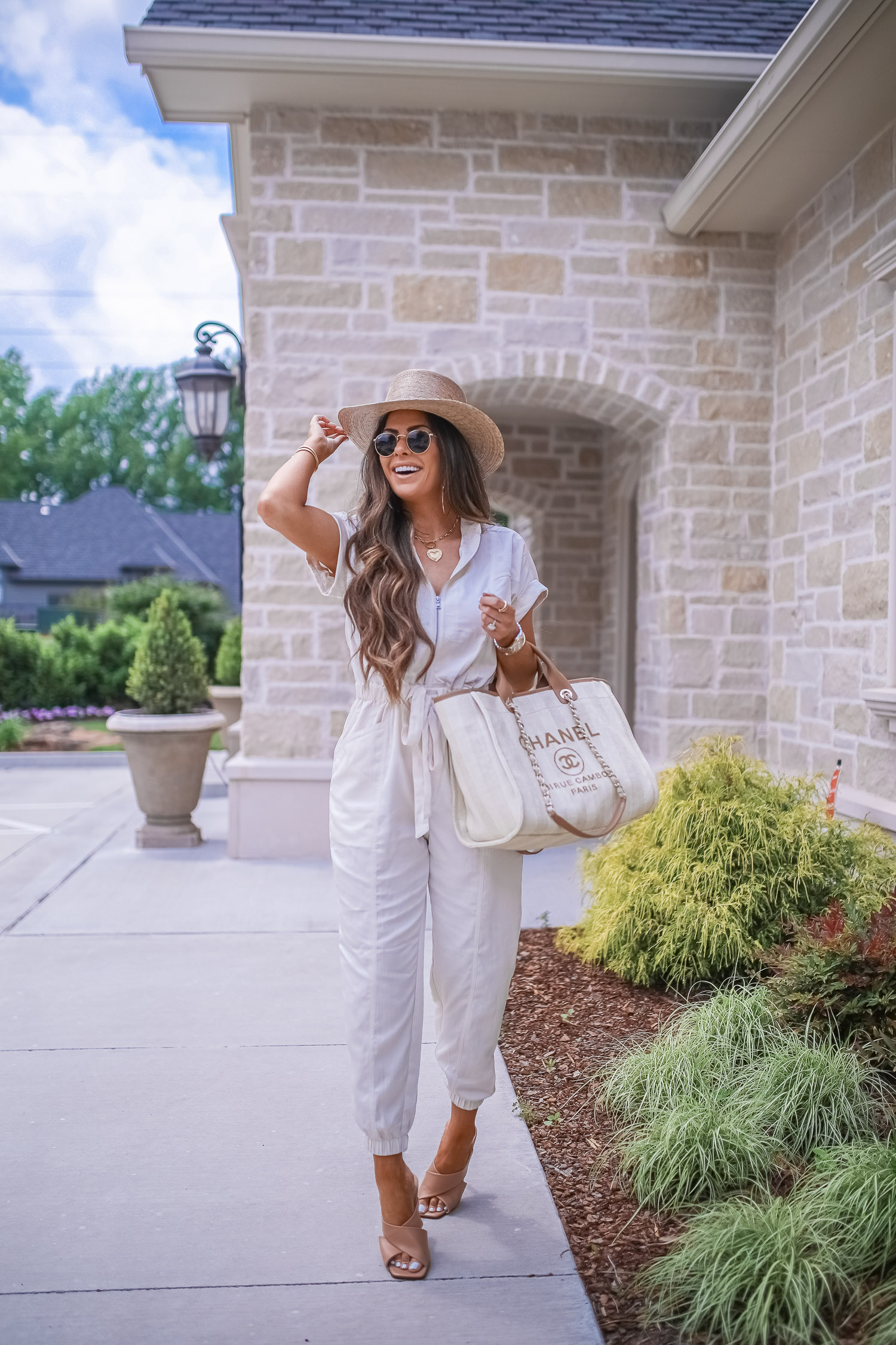 Instagram Recap by popular US life and style blog, The Sweetest Thing: image of Emily Gemma wearing a Express Zip Front Utility Jumpsuit, Lack of Color Hat, Express Large Metal Hoop Earrings, and holding a Chanel bag. 