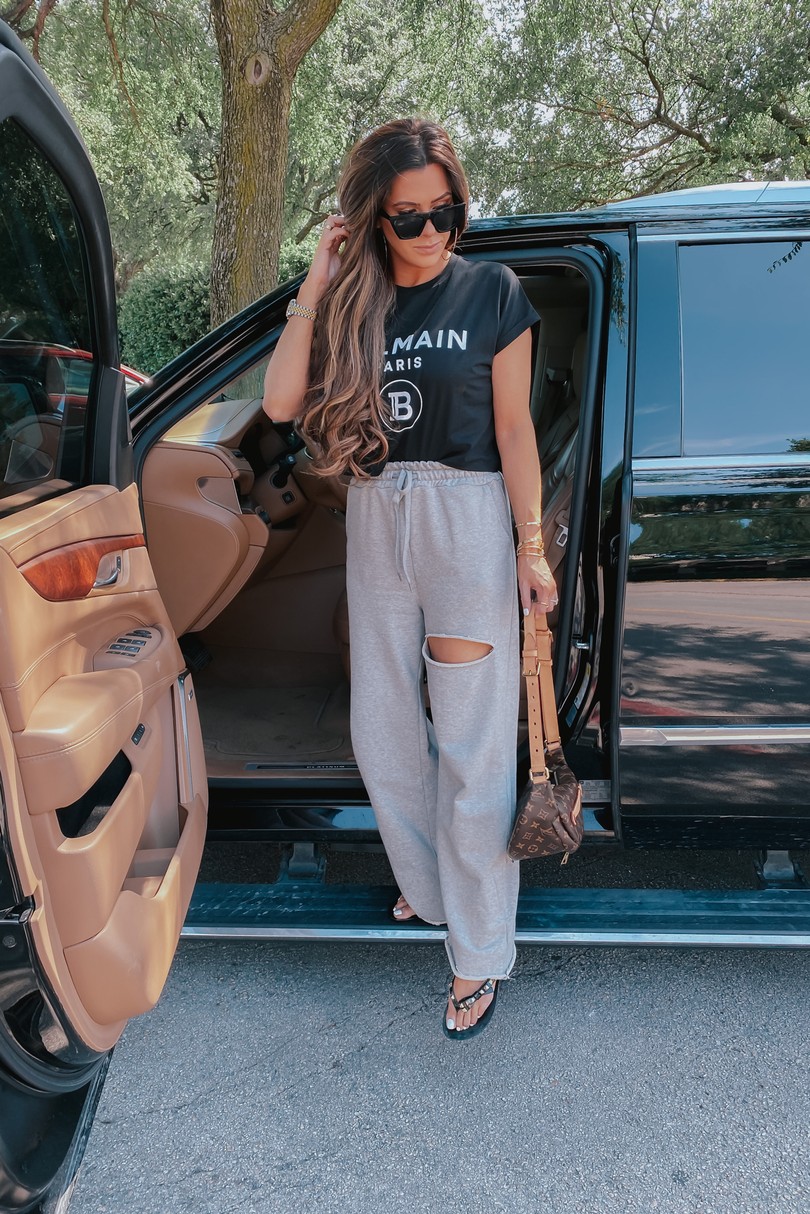 Instagram Recap by popular US life and style blog, The Sweetest Thing: image of Emily Gemma wearing a Balmain top, BP. sunglasses, Storets Nadia Slash Lounge Pants, Harmonic Studs Flip Flop MELISSA, and holding a Louis Vuitton bum bag. 