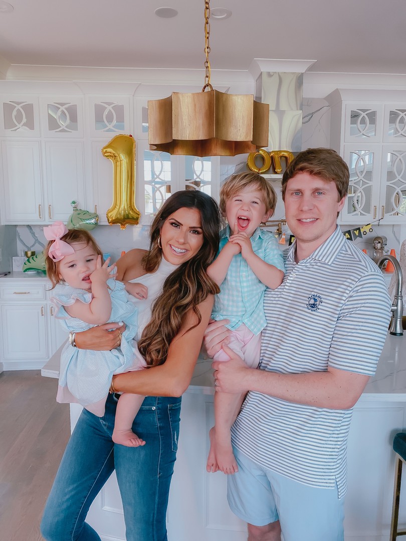 Instagram Recap by popular US life and style blog, The Sweetest Thing: image of Emily Gemma and her husband holding their two kids and wearing a Revolve Luz Knit Top superdown, and Good American jeans. 