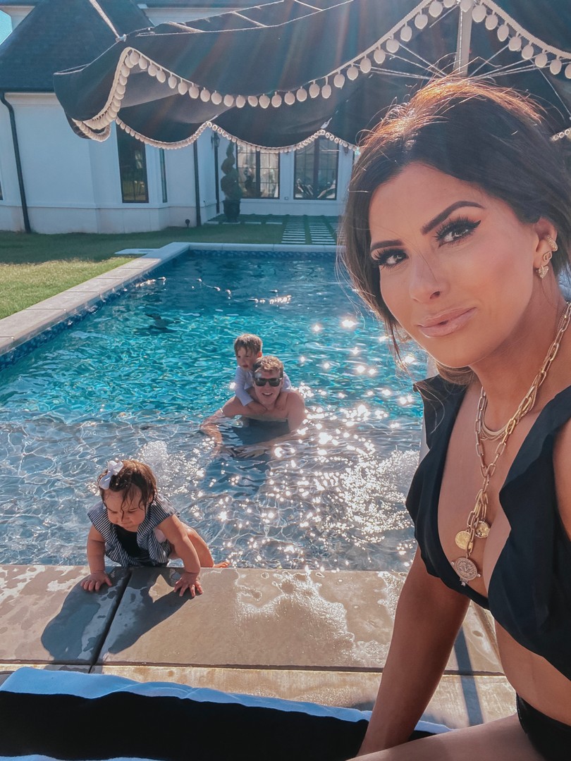 Instagram Recap by popular US life and style blog, The Sweetest Thing: image of Emily Gemma swimming in the pool with her husband and kids and wearing a Revolve Liz Bikini Top Vix Swimwear brand:Vix Swimwear, Revolve x REVOLVE Shiloh High Waist Bottom House of Harlow 1960 brand: House of Harlow 1960, Revolve Alex Duster L'Academie, Harmonic Studs Flip Flop MELISSA, BaubleBar LYDIE EAR CUFF SET, Free People Gold Rush Collection Collar Necklace, Target Fashion Forms Women's Water Wear Push-Up Pads, and Etsy Baby Lady Swim One Piece Girl Swimsuit Black with Striped Ruffles.