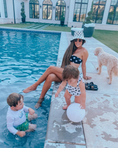 best bathing suits 2020, bathing suit coverups 2020, white coverups, pool style, high waisted swimsuits 2020, flattering swimsuits 2020, Emily Gemma | Instagram Recap by popular US life and style blog, The Sweetest Thing: image of Emily Gemma and her two children playing in a swimming pool and wearing a MARA HOFFMAN Abigail Bandeau Bikini Top, MARA HOFFMAN Goldie High-Waist Bikini Bottoms, ASOS DESIGN fisherman hat in polka dot, Crystal Pavé Chain Anklet ETTIKA, Maisonette Snapper Rock Black & White Spot Skirt Swimsuit, and Amazon KoroBeauty Hair Bows. 