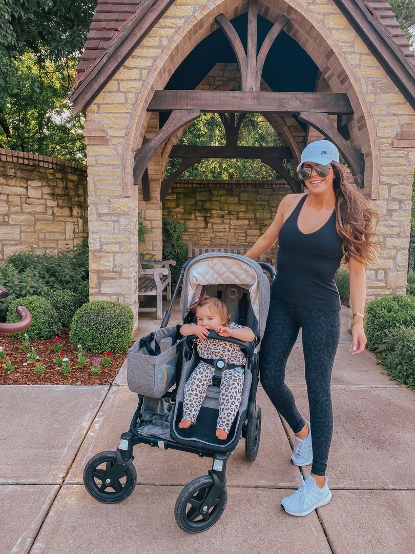 Instagram Recap by popular US life and style blog, The Sweetest Thing: image of Emily Gemma pushing her daughter in a Bugaboo stroller and wearing a Alo top, Lululemon leggings, Nike hat, and Adidas sneakers.