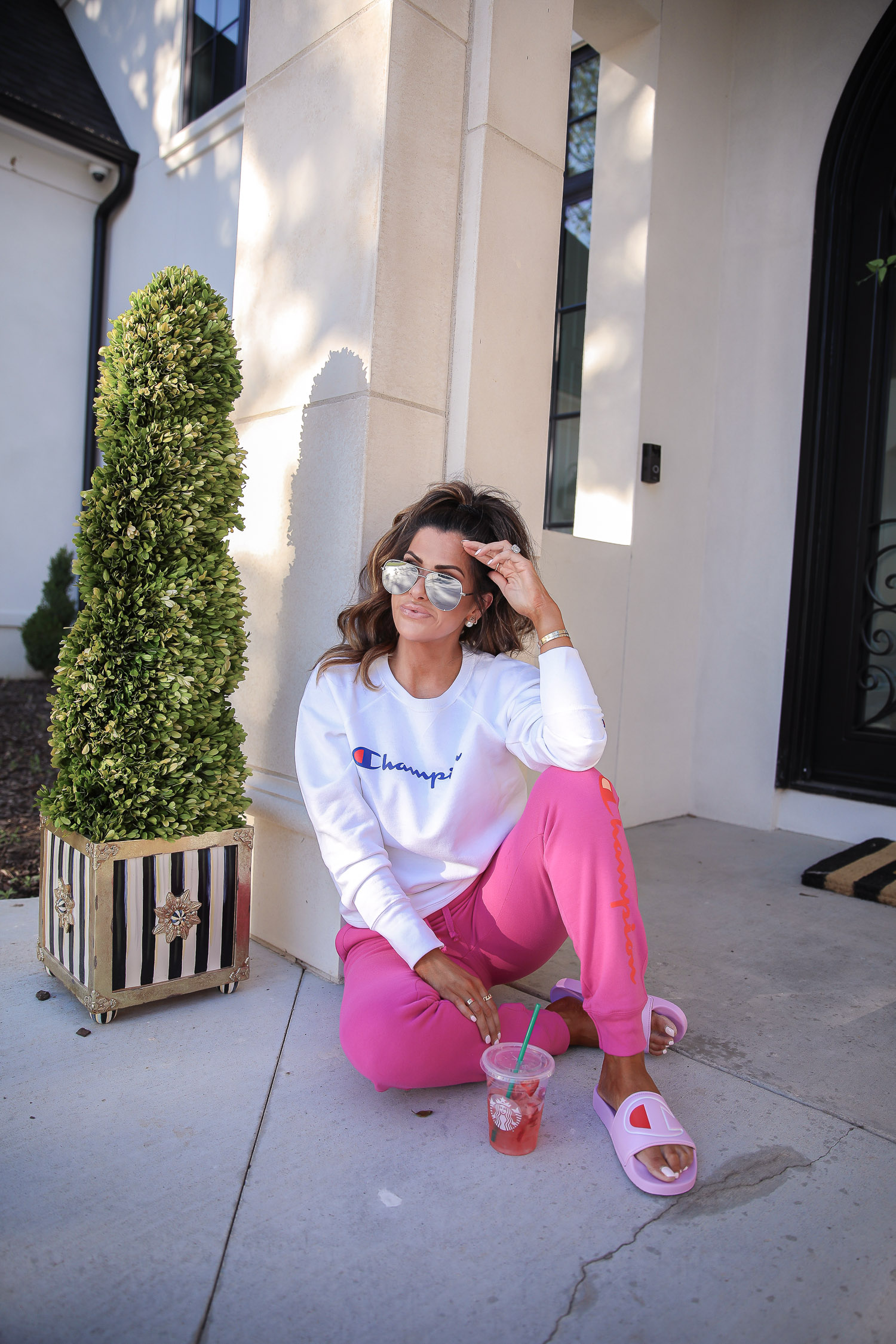 champion sweatshirt, pink champion slides, walmart fashion 2020, emily gemma, walmart champion outfit | Champion Outfit by popular US fashion blog, The Sweetest Thing: image of Emily Gemma sitting outside and wearing a Walmart Champion Women's Powerblend Fleece Boyfriend Crew Neck Sweatshirt, Walmart Champion Women's Powerblend Fleece Joggers-Graphic, Walmart Champion Women's IPO Slide, Walmart Revlon Super Lustrous Lipstick, Walmart NYX Professional Makeup Retractable Lip Liner, and Walmart e.l.f. Lip Plumping Gloss.