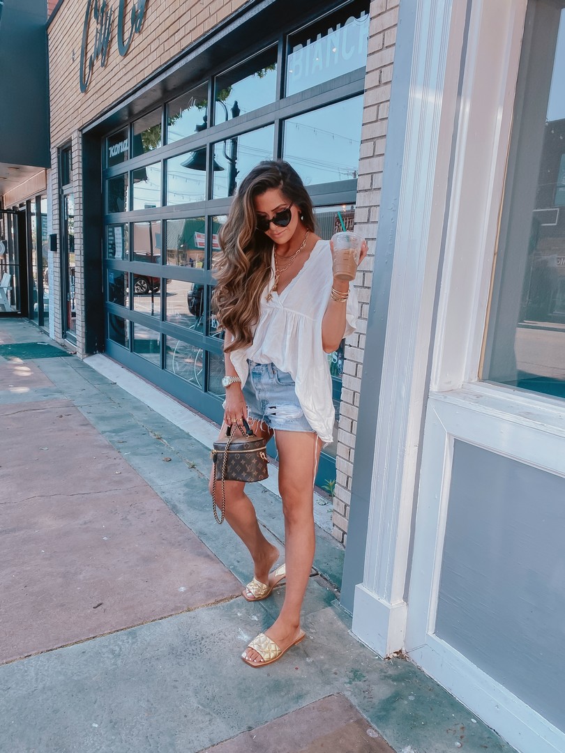 Instagram Recap by popular US life and style blog, The Sweetest Thing: image of Emily Gemma wearing a Free People tunic top, Levi's shorts, gold slide sandals, cartier bracelets, Cartier rings, Fendi Rings, Dior rings, Nordstrom Pave huggie earrings, and holding a Louis Vuitton bag. 