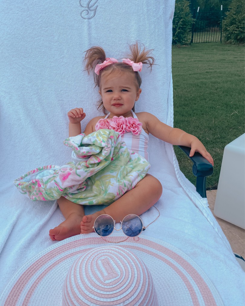 Instagram Recap by popular US life an style blog, The Sweetest Thing: image of Emily Gemma's daughter Sophie sitting in a lounge chair outside on a Smocked Auctions monogram towel next to a Janie and Jack sun hat and wearing a Janie and Jack swimsuit, 