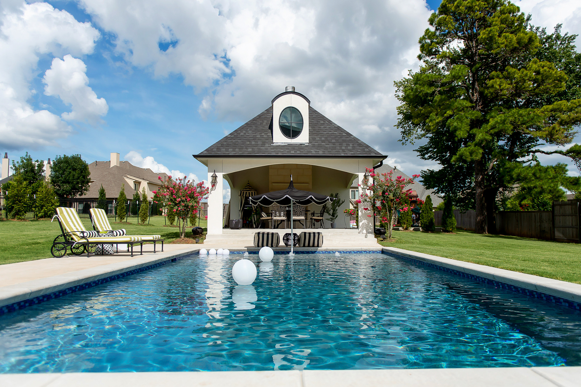 Blog Design by popular US lifestyle blog, The Sweetest Thing: image of a outdoor swimming pool with a pool house. 