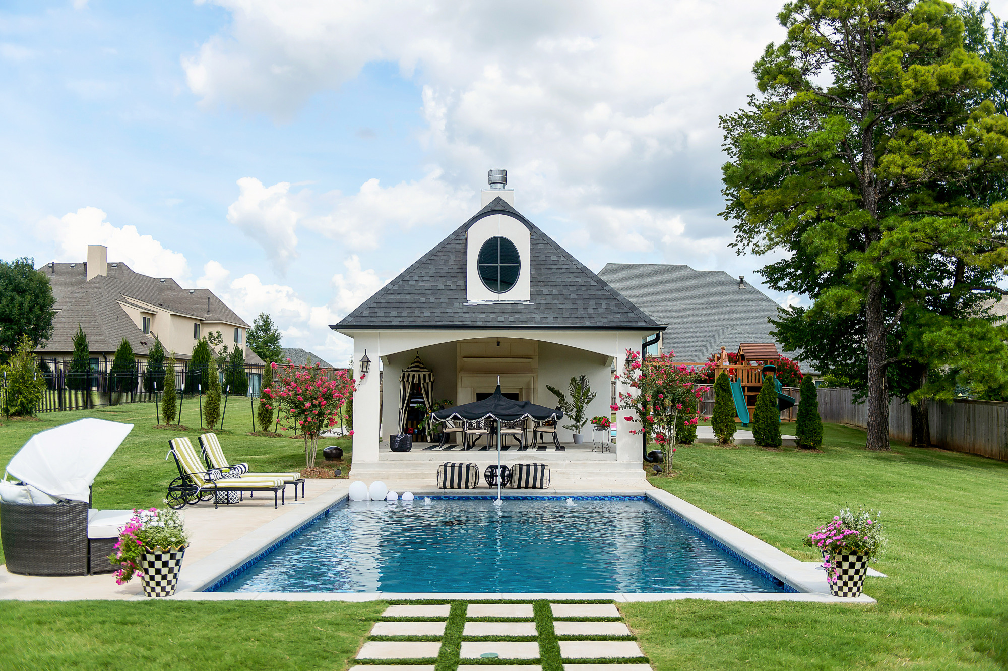 Blog Design by popular US lifestyle blog, The Sweetest Thing: image of a outdoor swimming pool with a pool house. 