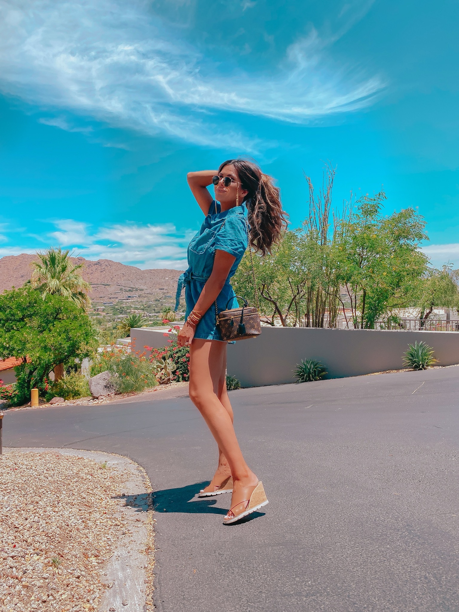 jean romper, sunglass chain, Louis Vuitton vanity bag, Emily Gemma, scottsdale outfit inspiration, scottsdale outfit ideas, Steve Madden wedges, best nude wedges | Instagram Recap by popular US life and style blog, The Sweetest Thing: image of Emily Gemma wearing a H & M Denim Romper, Steve Madden FLORETTA COGNAC LEATHER Wedge sandals, BP 48mm Round Metal Sunglasses, Cartier bracelets, Fendi GLASSES CHAIN, and Net-a-porter CHLOÉ Alphabet gold-tone necklace. 