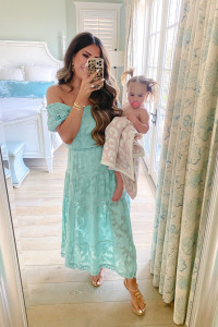 summer fashion 2020, maxi Dress, beach outfits, Emily Ann Gemma |Instagram Recap by popular US life and style blog, The Sweetest Thing: image of Emily Gemma holding her daughter wrapped in a Barefoot Dreams blanket and wearing a Rahi dress, Chanel shoes, Cartier ring, and Rolex watch.