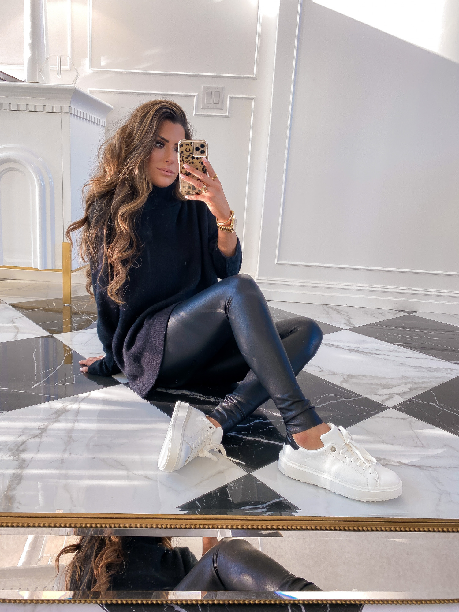 NSALE 2021 commando leggings, best legggings NSALE 2021, mcqueen sneaker dupes NSALE | Nordstrom Anniversary Sale by popular US fashion blog, The Sweetest Thing: image of Emily Gemma wearing a black Free People turtleneck sweater, Commando faux leather leggings, and white sneakers. 