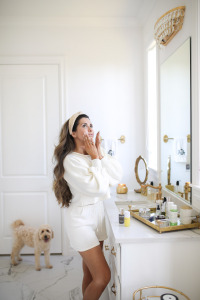 beauty counter review vitamin C, Beauty Counter Sephora overnight resurfacing gel, emily ann gemma |Instagram Recap by popular US life and style blog, The Sweetest Thing: image of Emily Gemma wearing a Hello Molly top, Hello Molly shorts, and Lele Sadoughi headband and standing next to a Anthropologie mirror, Anthropologie candle, and Carter tray containing BeautyCounter serum and BeautyCounter overnight peel. 