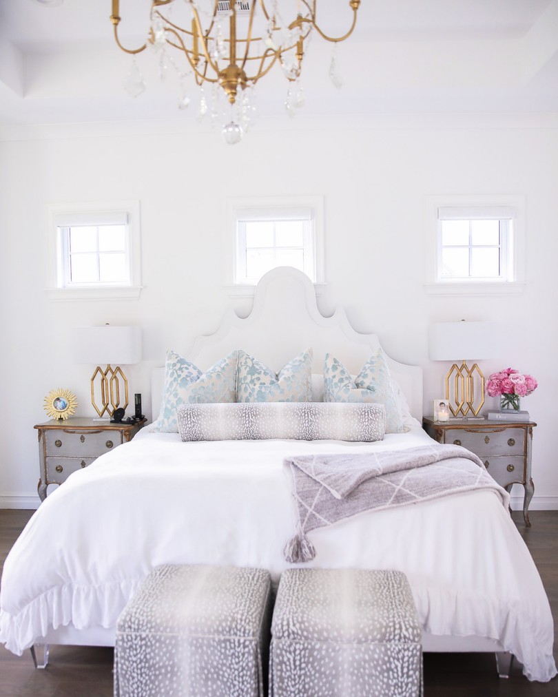 home decor, nsale home finds, Nordstrom sale home decor, Emily Ann Gemma, Bright white bedroom ideas |Instagram Recap by popular US life and style blog, The Sweetest Thing: image of a master bedroom decorated with a My Chic Nest bed, gold lamps, grey night stands, antelope print ottomans, white duvet, and gold and crystal chandelier. 