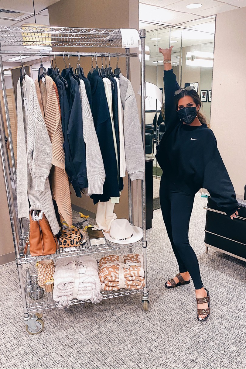 NSALE 2020, Nordstrom Sale try on, Fall Fashion, Emily Ann Gemma |Instagram Recap by popular US life and style blog, The Sweetest Thing: image of Emily Gemma standing next to a clothing rack and wearing a Nike sweatshirt, Zella leggings, and a Slip face mask. 