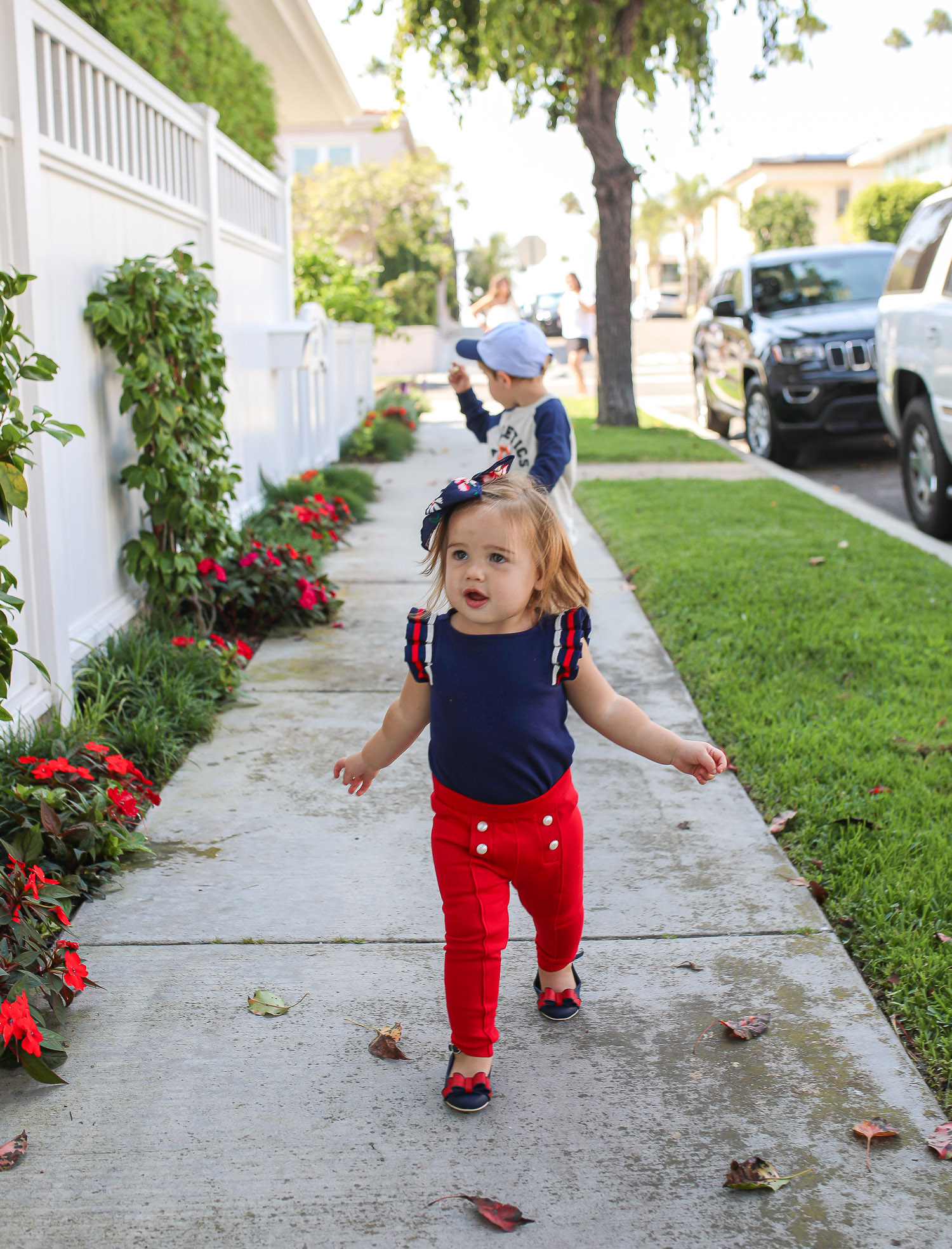 Instagram Recap by popular US life and style blog, The Sweetest Thing: image of a little girl and boy walking outside on a sidewalk on Balboa Island and wearing a Janie and Jack Raglan Tiger Sweatshirt, Stripe Trim Jogger, Tiger Patch Cap, Pleated Sleeve Top, Button Ponte Pant, Bow Ankle Strap Flat, loral Bow Barrette.