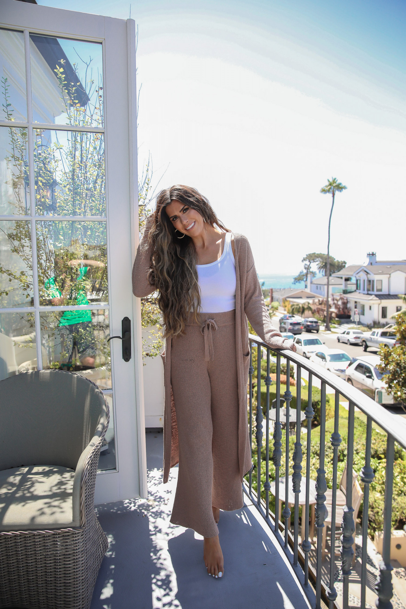skinceuticals neck cream tripeptide-r neck repair, best neck cream for wrinkles crepes, best skincare product for neck, emily ann gemma,_ | Skincare Product by popular US beauty blog, The Sweetest Thing: image of Emily Gemma standing outside on a balcony. 