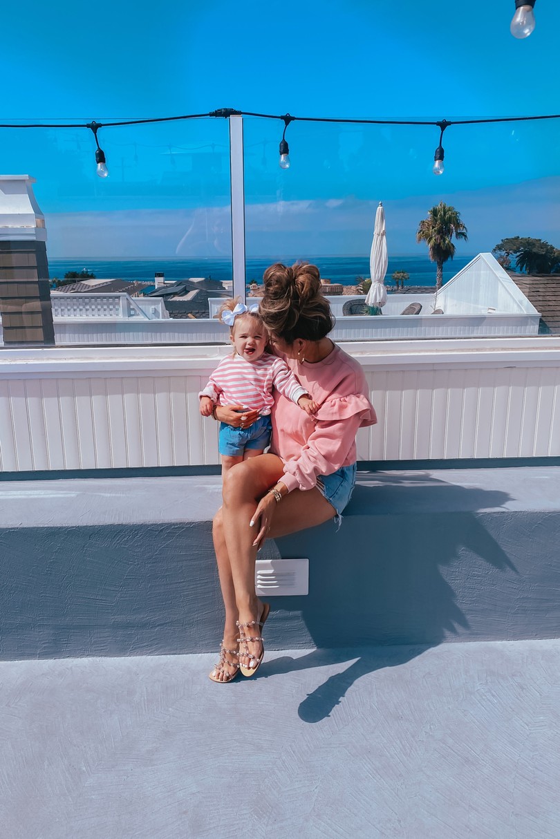 Instagram Recap by popular US lifestyle blog, The Sweetest Thing: image of Emily Gemma wearing a pink ruffle sleeve H&M sweatshirt, Schutz sandals, and BlankNYC jean shorts. 